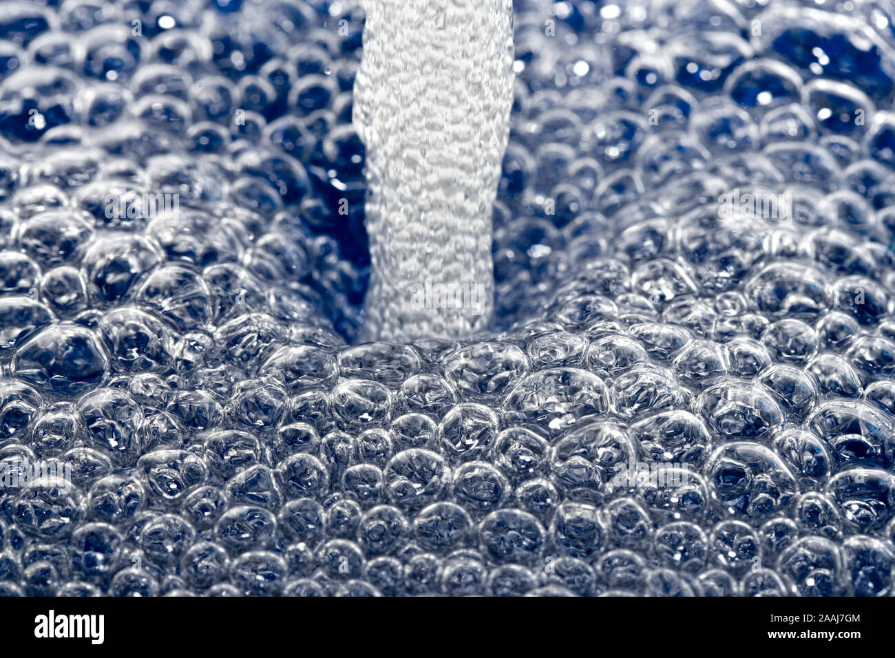 A jet of water generating bubbles Stock Photo