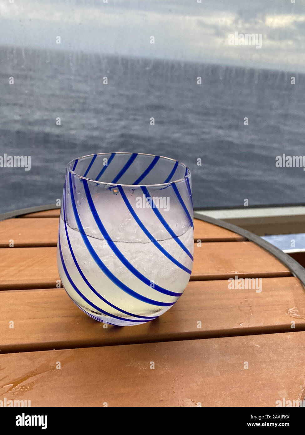 An alcoholic beverage of vodka and lemonade on a table aboard a cruise
