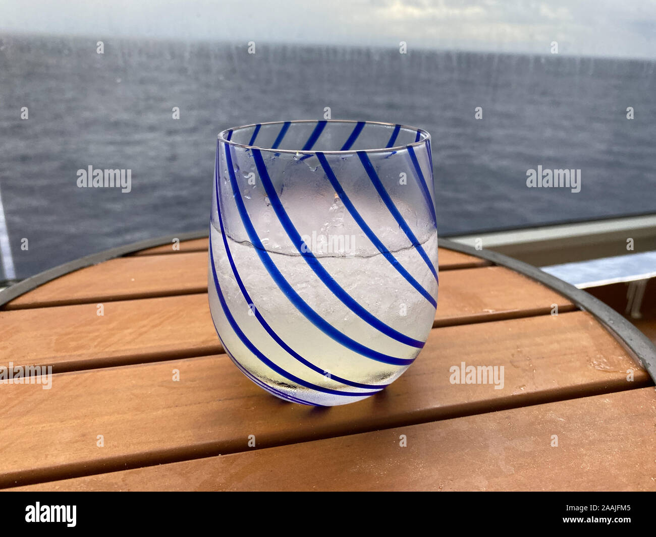 An alcoholic beverage of vodka and lemonade on a table aboard a cruise