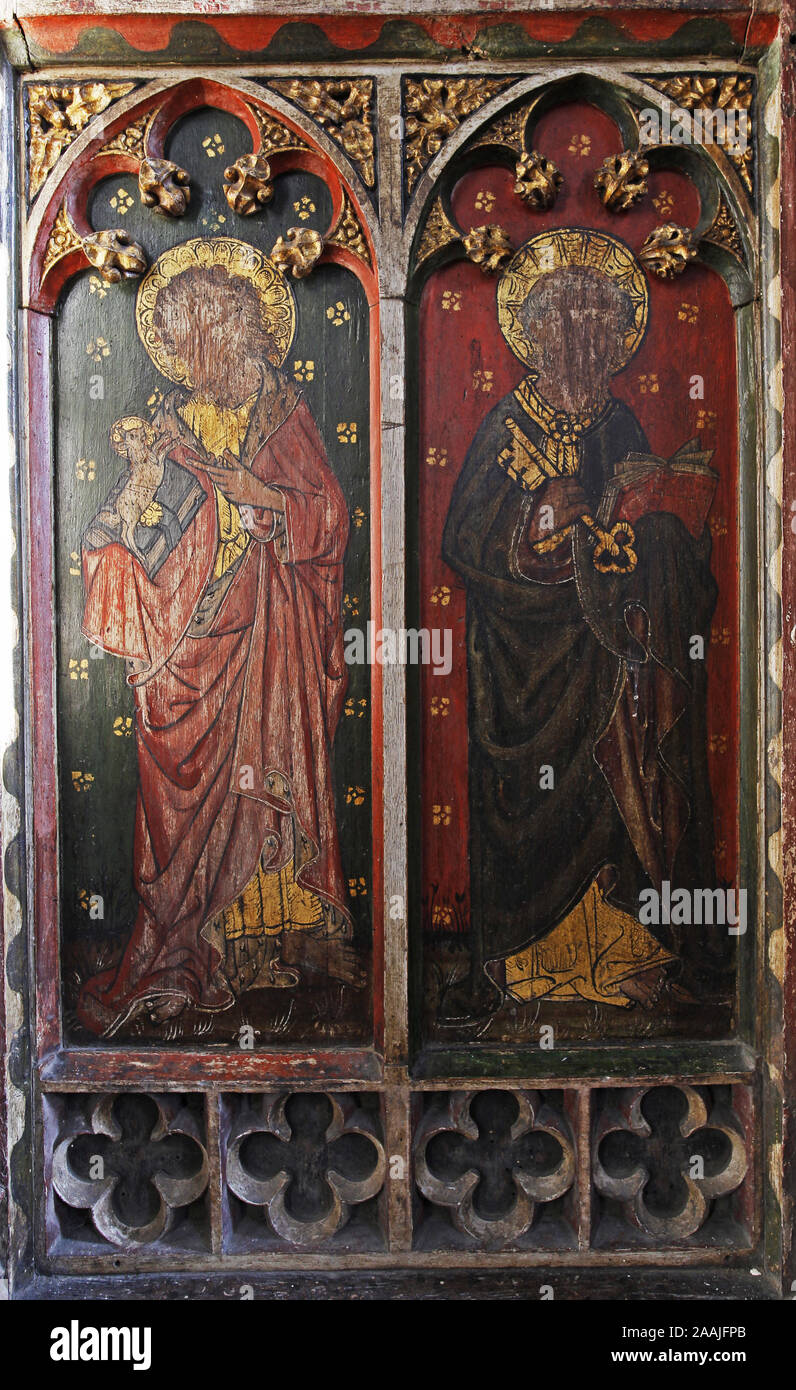 Painted rood screen depicting Ss John the Baptist & Peter, heavily defaced during the iconoclasm of the c17th, St Peter's Church, Belaugh, Norfolk Stock Photo