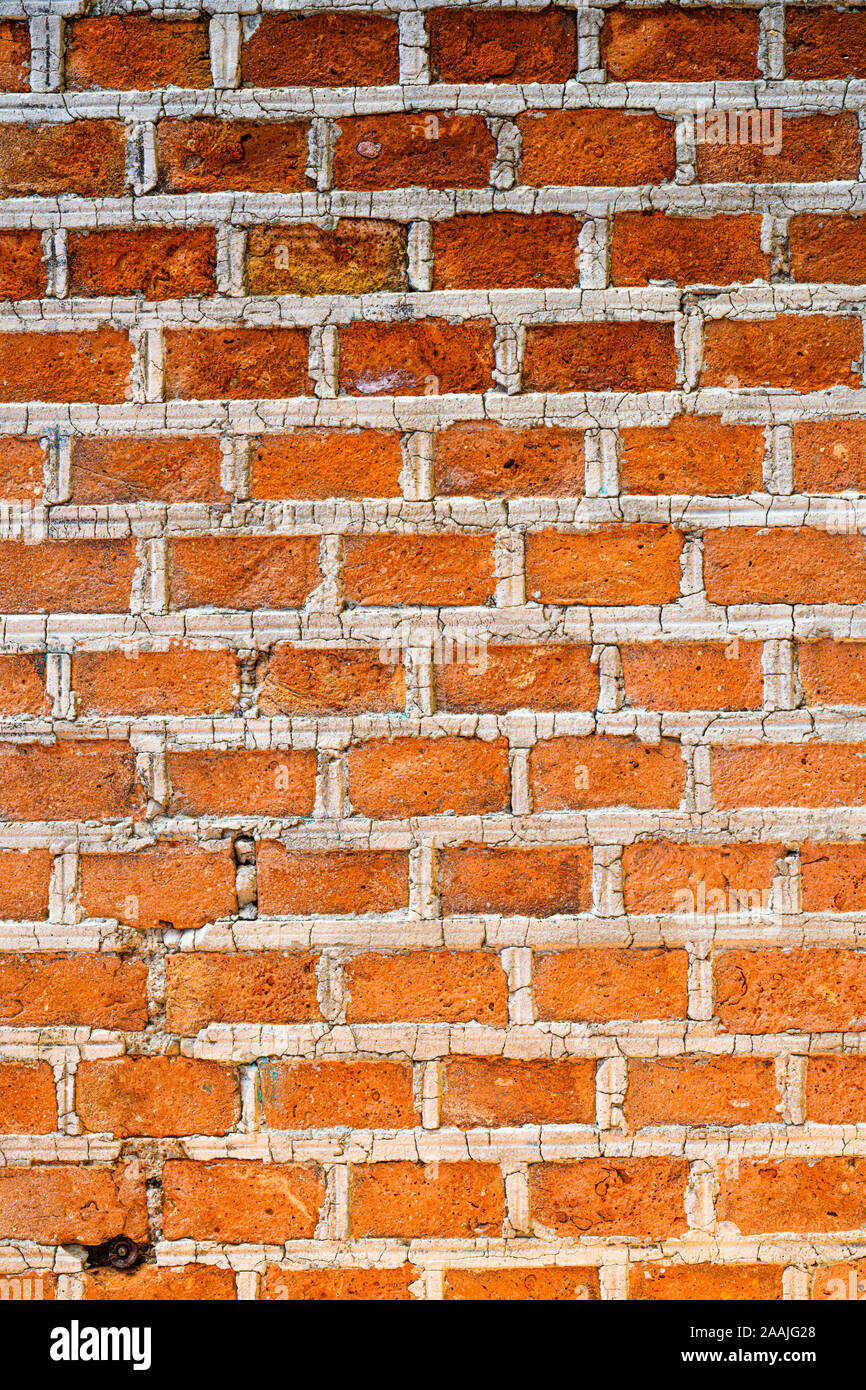 Texture background of red bricks wall, a continuous vertical brick  structure that encloses or divides an area of land. Stock Photo