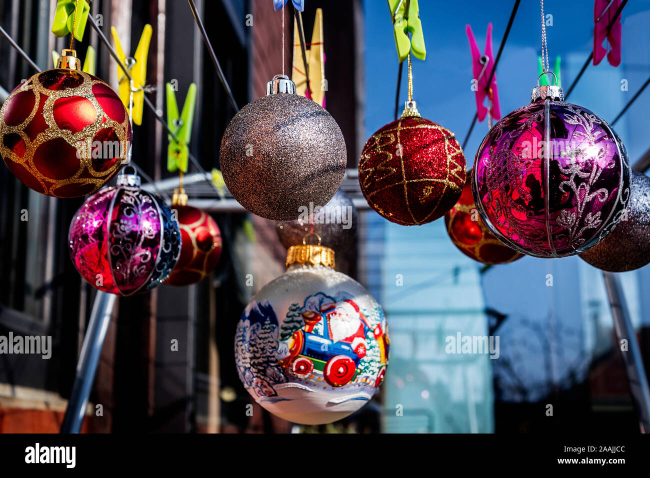 Beautiful Christmas Balls Ornaments hanging on the clips on the  Clothes Drying Rack. Stock Photo