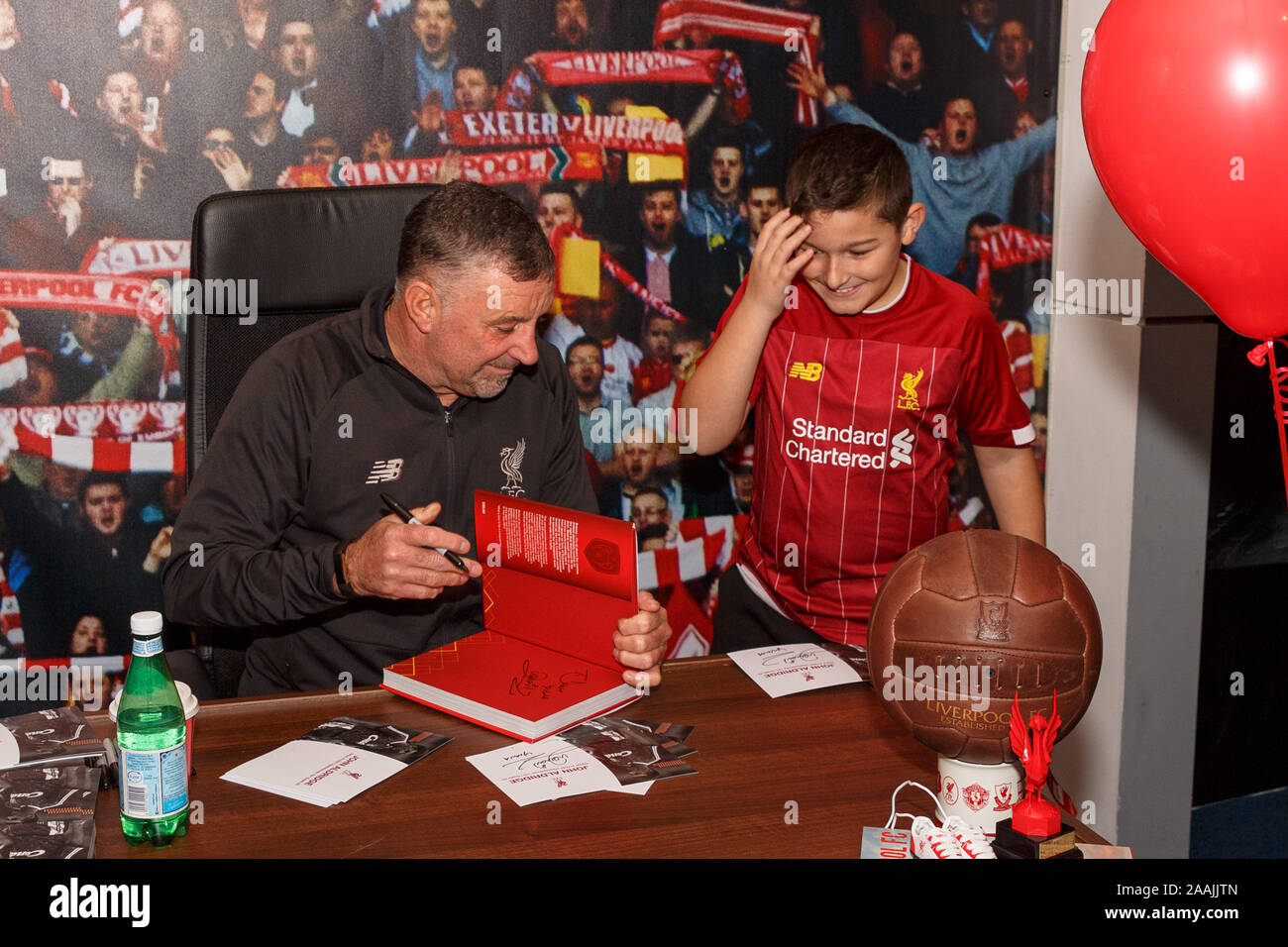 Cork, Ireland,  22nd November 2019. John Aldridge Meet and Greet at Liverpool FC Store, Cork City.  John Aldridge signing Mikail Farooq's (Wexford) LFC Book. People lined up in their masses in the pop up Liverpool FC Store on Maylor Street at pm today to attend a meet and greet with former football player and manager, John Aldridge. Credit: Damian Coleman Credit: Damian Coleman/Alamy Live News Stock Photo