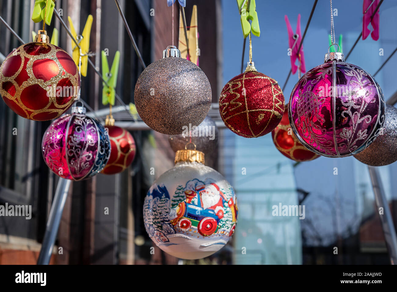 Christmas Balls Ornaments hanging on the clips on the  Clothes Drying Rack. Stock Photo