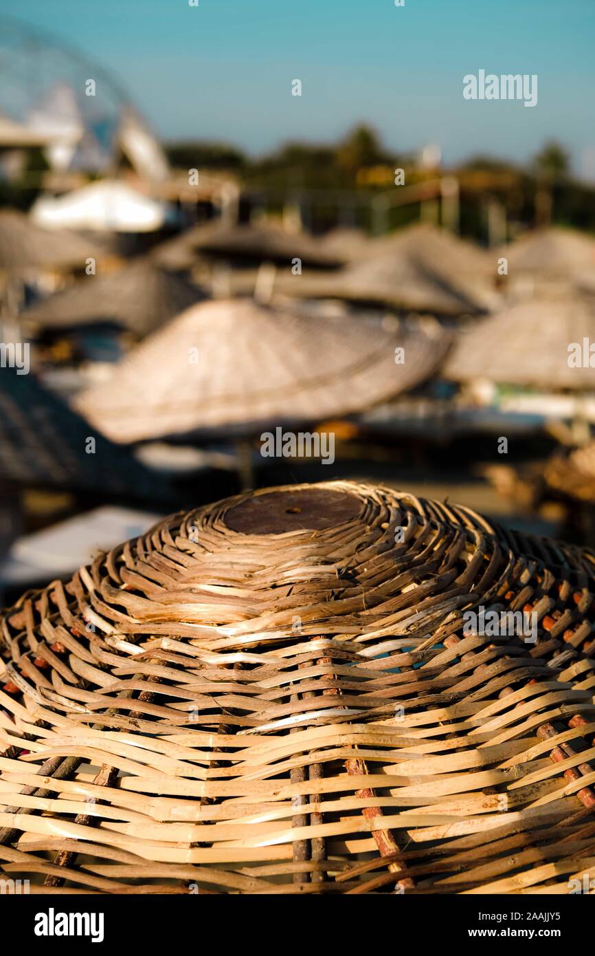 Natural bamboo reed straw beach umbrella. Closeup. selective focuse. Stock Photo