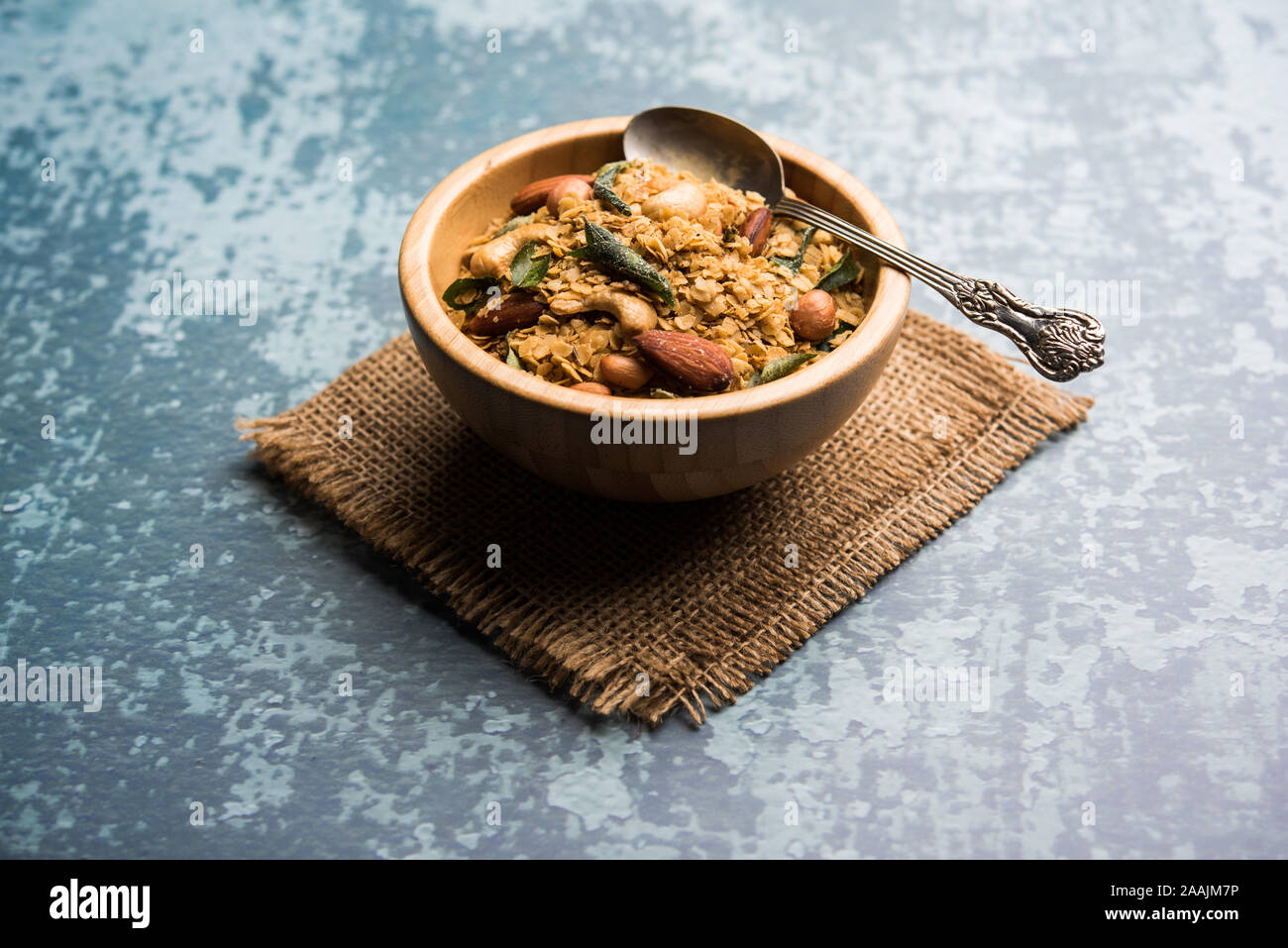 Oats Chivda / Chiwda is a healthy indian recipe with added chilli, peanuts, cashew, almond and curry leaf for flavour. Selective focus Stock Photo
