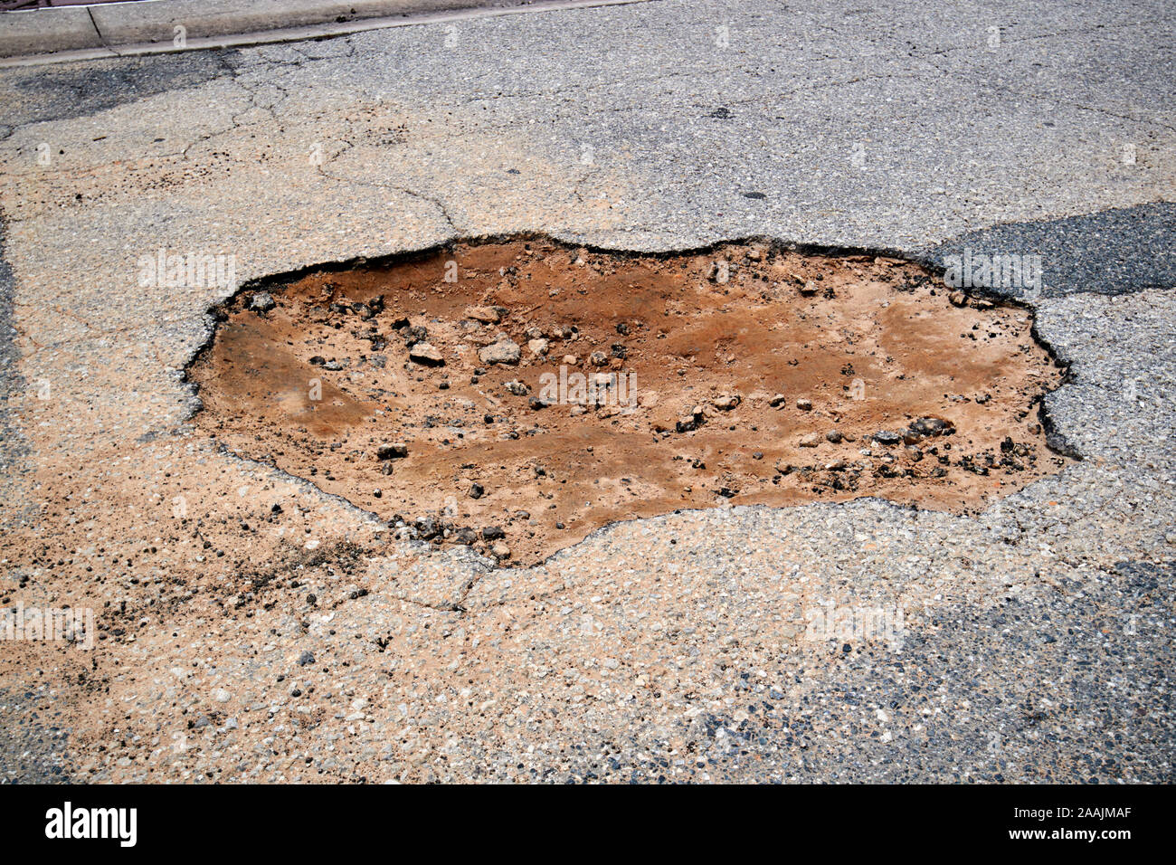 pothole in a florida tarmac road showing sandy substrate underneath florida usa Stock Photo