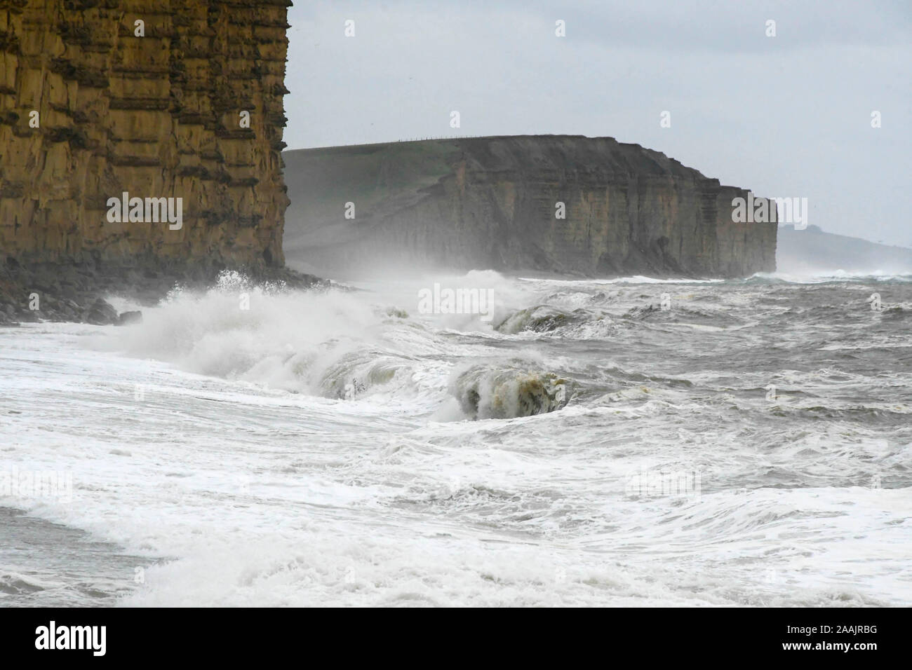 West Bay, Dorset, UK.  22nd November 2019.  UK Weather. Rough seas crash ashore on the beach at West Bay in Dorset after a morning of heavy rain.  Picture Credit: Graham Hunt/Alamy Live News Stock Photo