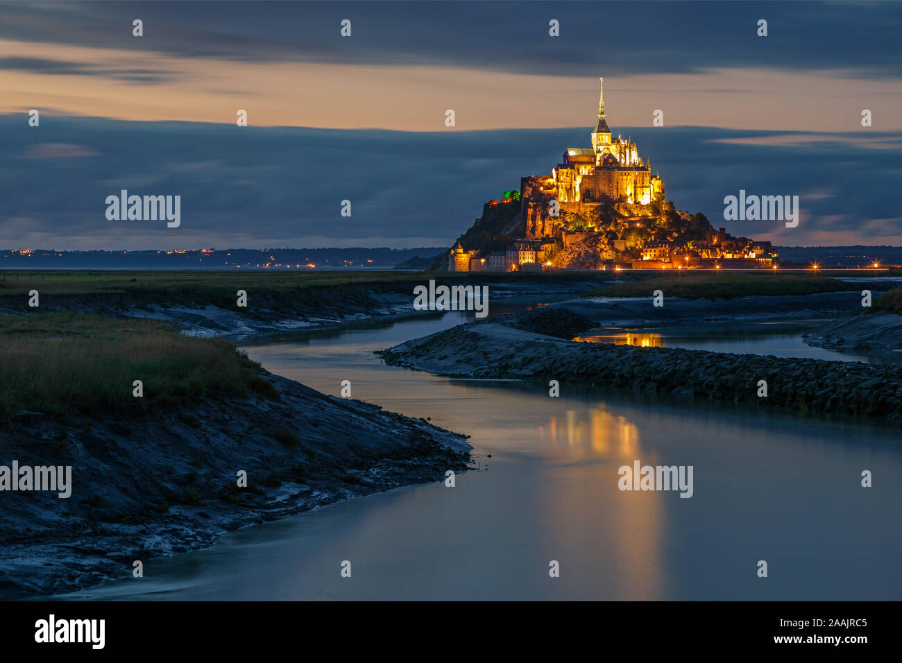 Normandy, France. The illuminated Mont Saint Michel is reflected on the water Stock Photo
