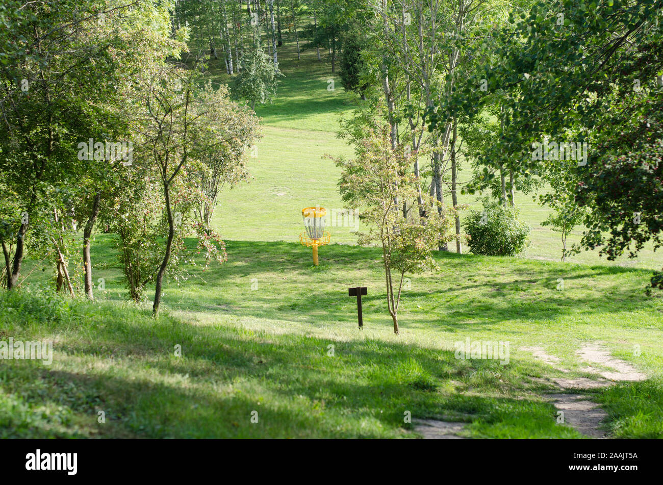 A view of a basket on a course of discgolf on a sunny summers day. Stock Photo