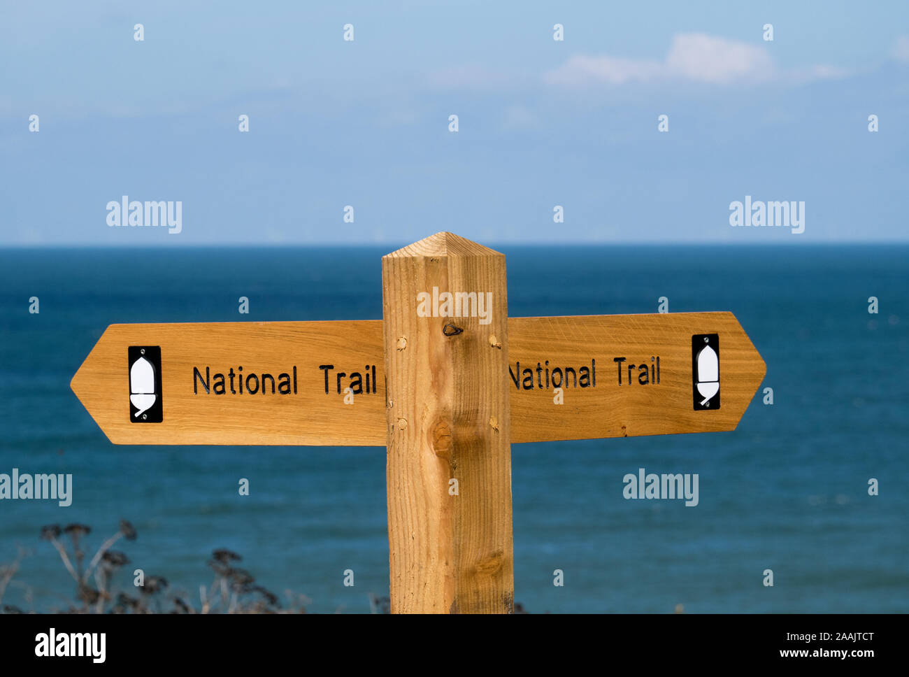 A Wooden Signpost for The National Trail, on The North Norfolk Path, with The North Sea beyond, Cromer, Norfolk, England, UK Stock Photo