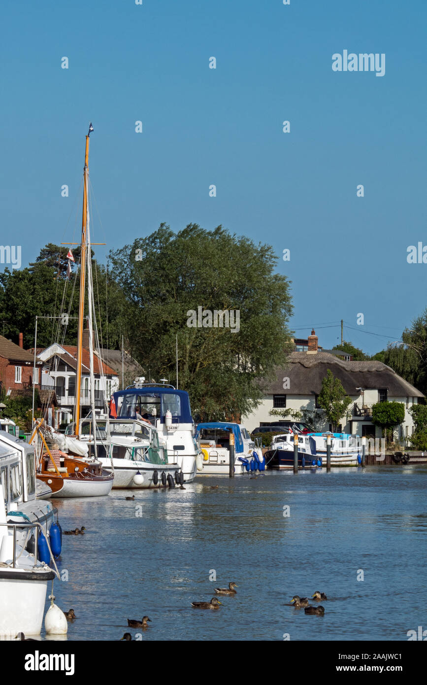 Boating on the River Yare, part of The Norfolk Broads National Park, at the Village of Reedham, Norfolk, England, UK Stock Photo