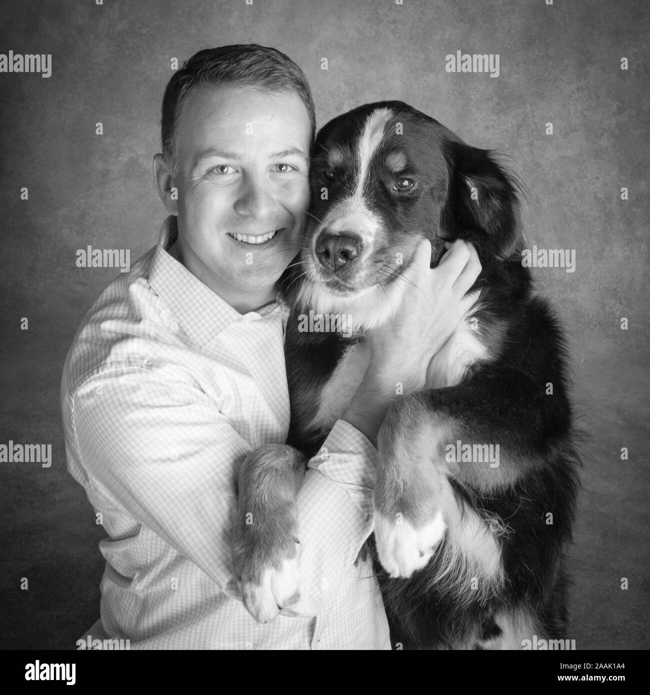 Portrait of man with Bernese Mountain Dog Stock Photo