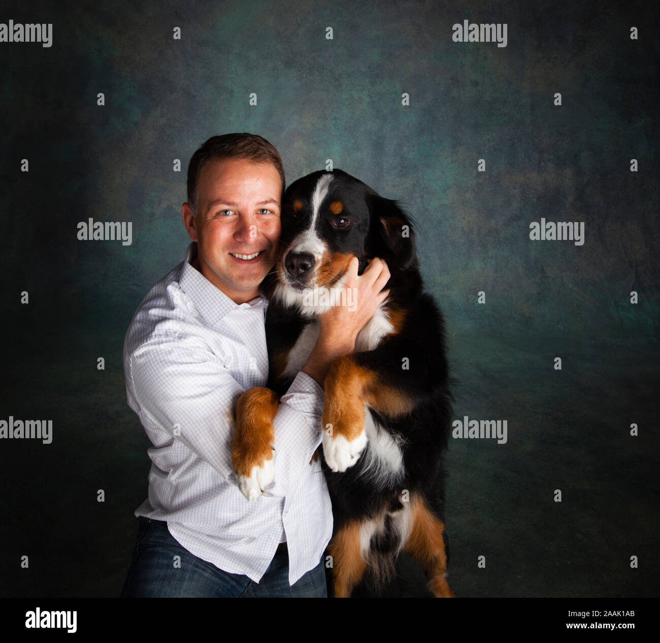 Portrait of man with Bernese Mountain Dog Stock Photo
