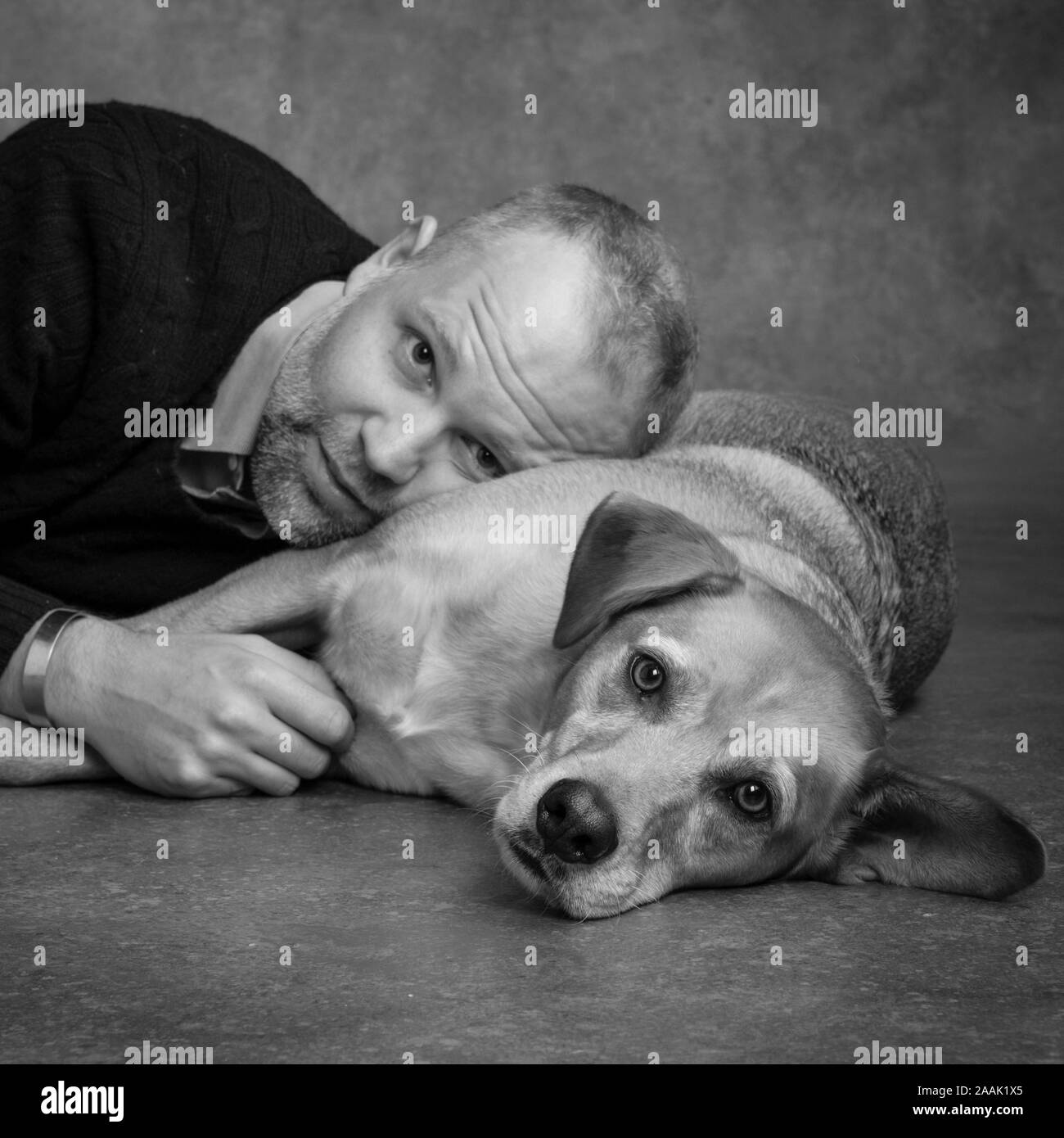 Studio portrait of man with Redbone Coonhound Stock Photo