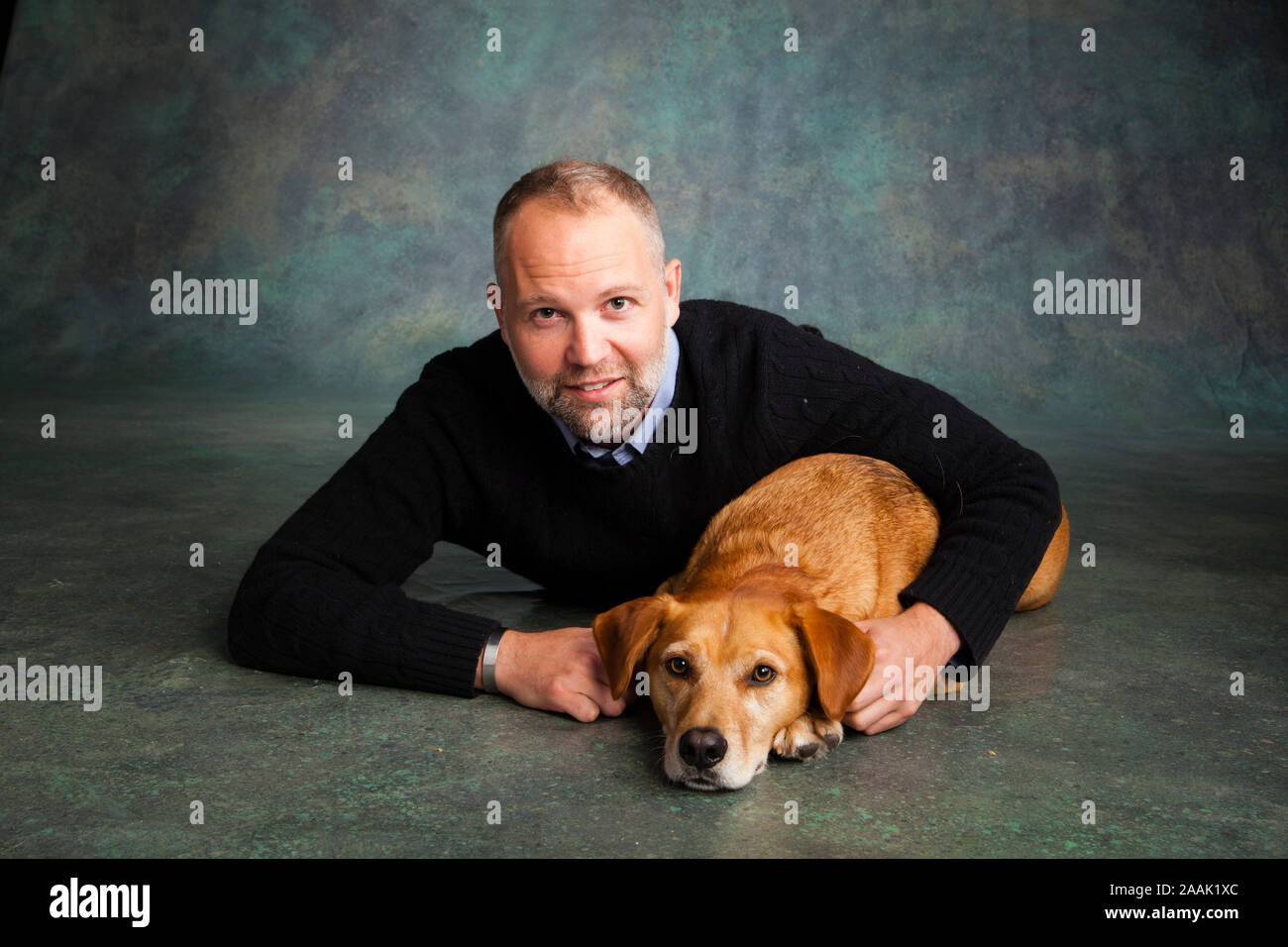 Studio portrait of man with Redbone Coonhound Stock Photo