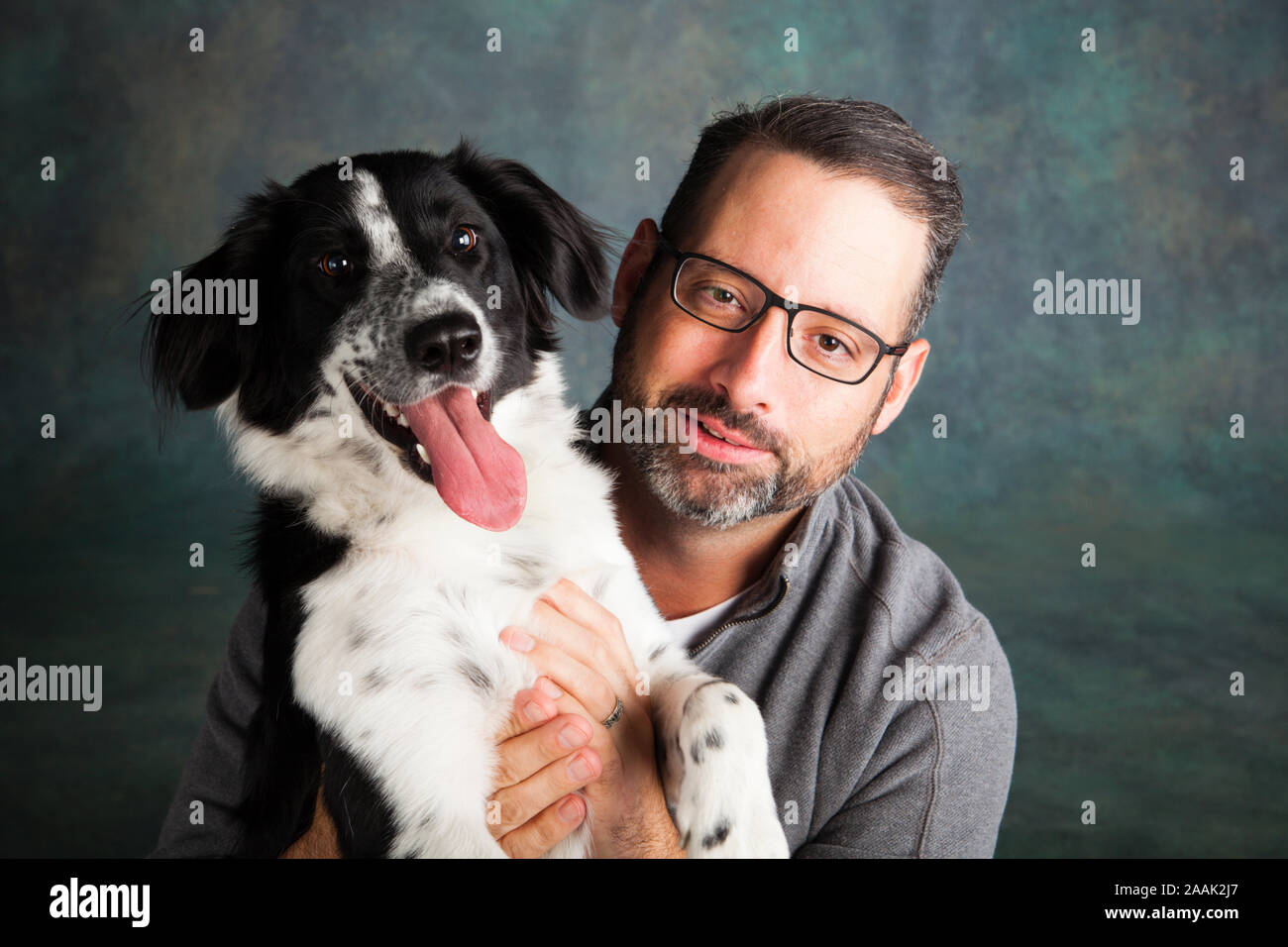 Studio portrait of man with Border Collie Mix Stock Photo