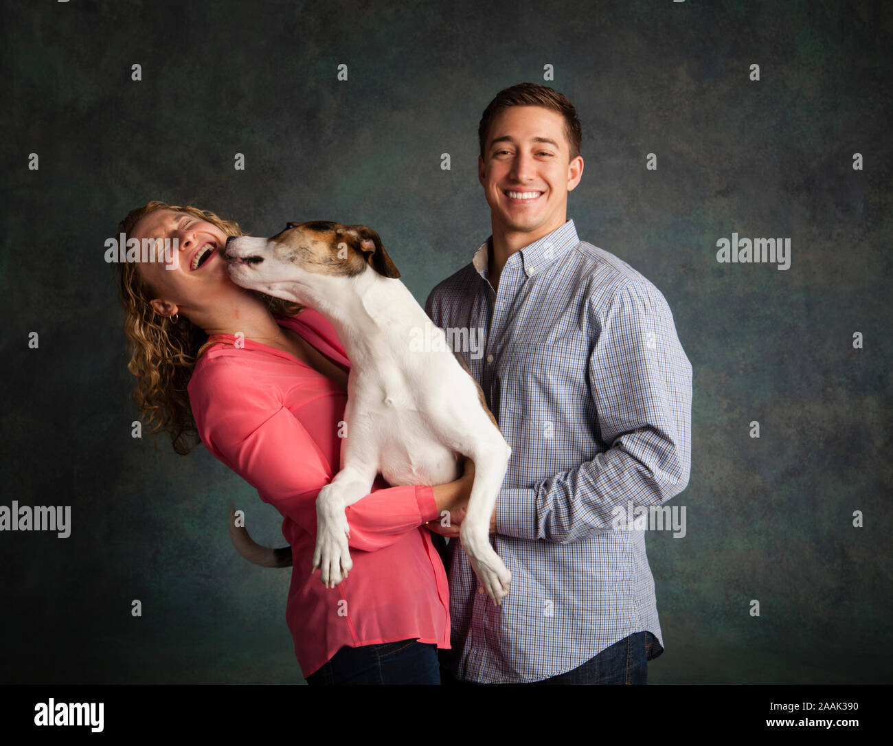 Studio shot of couple with mixed breed dog Stock Photo