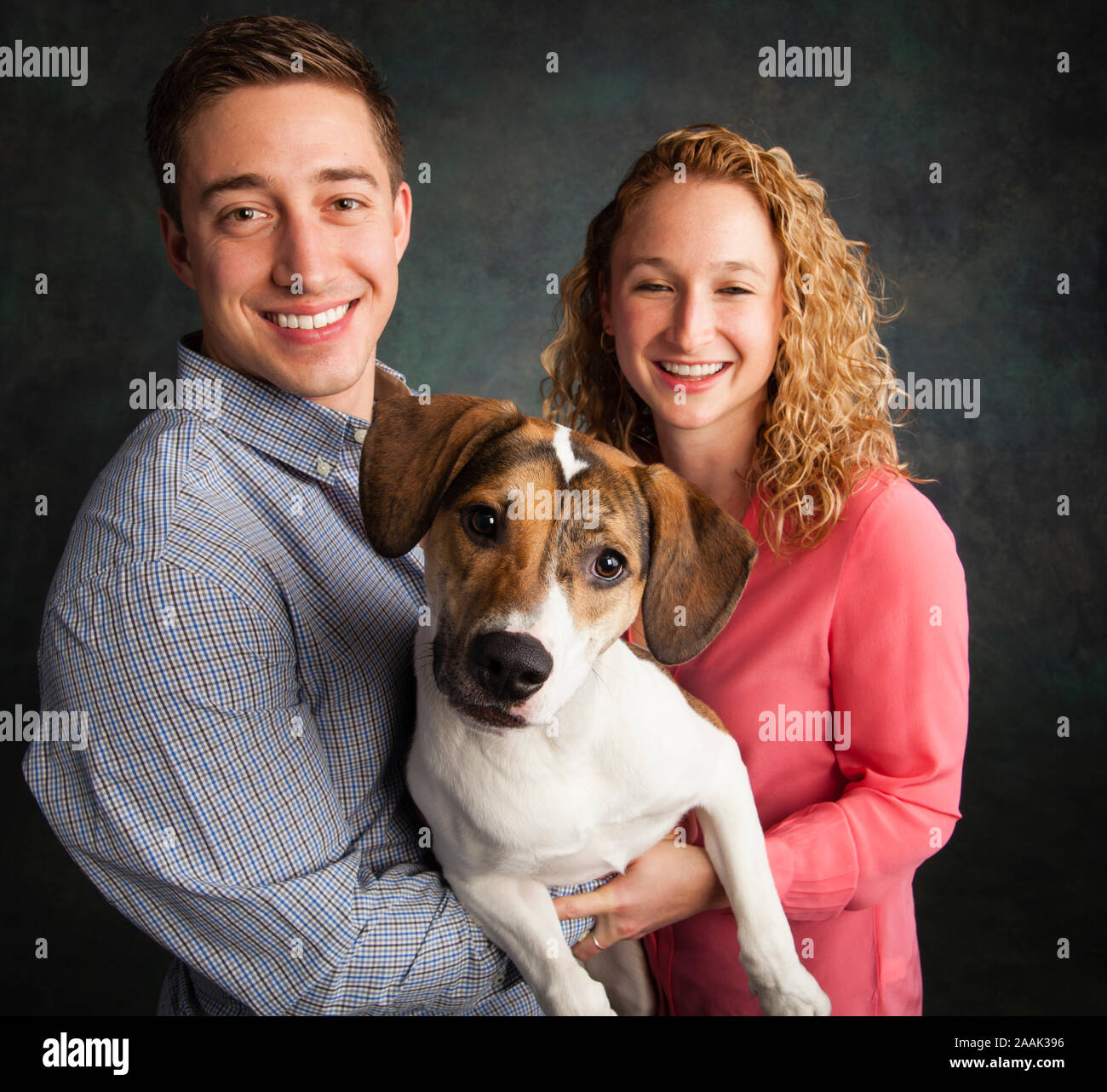 Studio portrait of couple with mixed breed dog Stock Photo