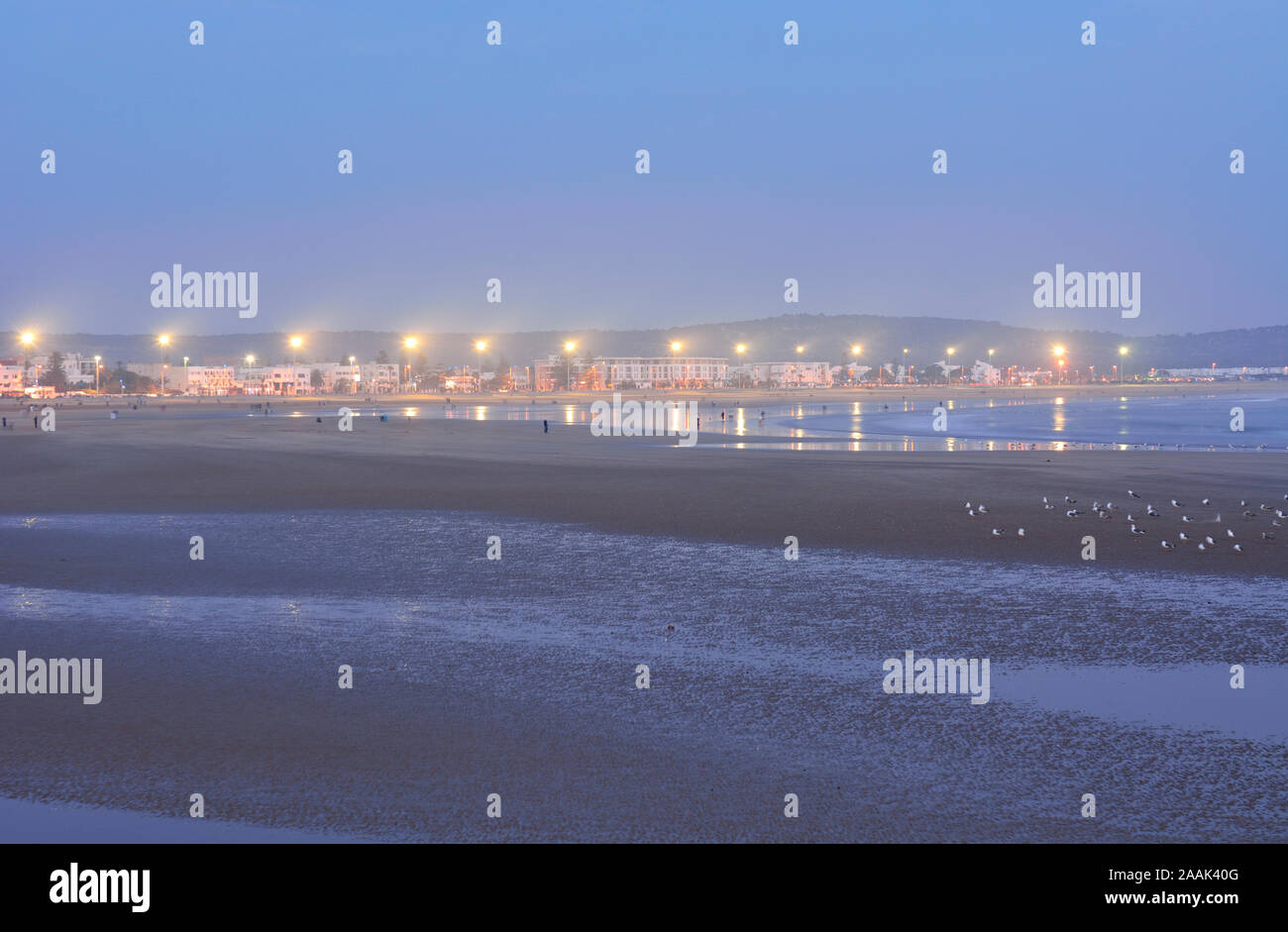 The vast sandy beach of Essaouira at twilight. Morocco Stock Photo