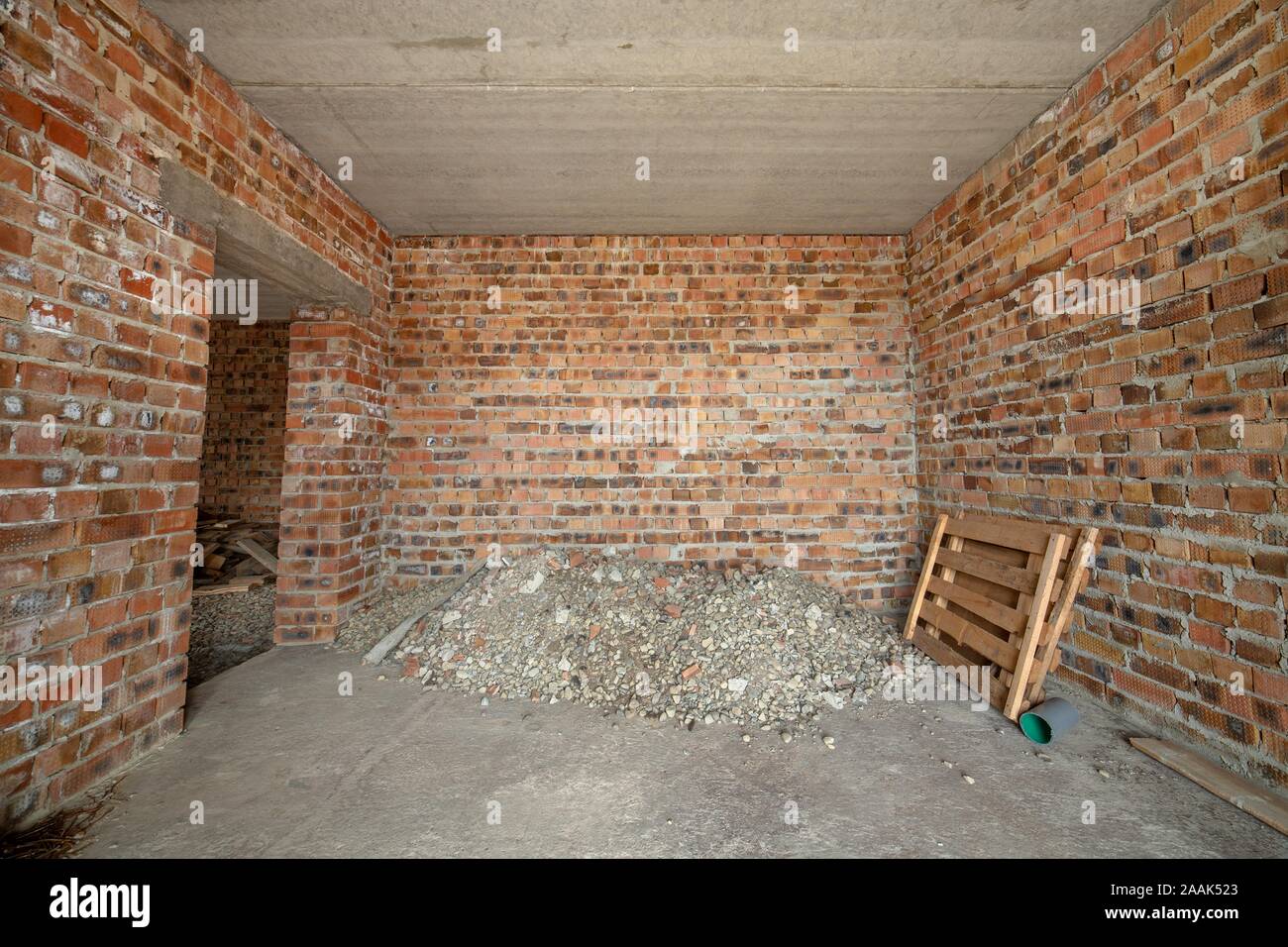 Interior Of Unfinished Brick House With Concrete Floor And