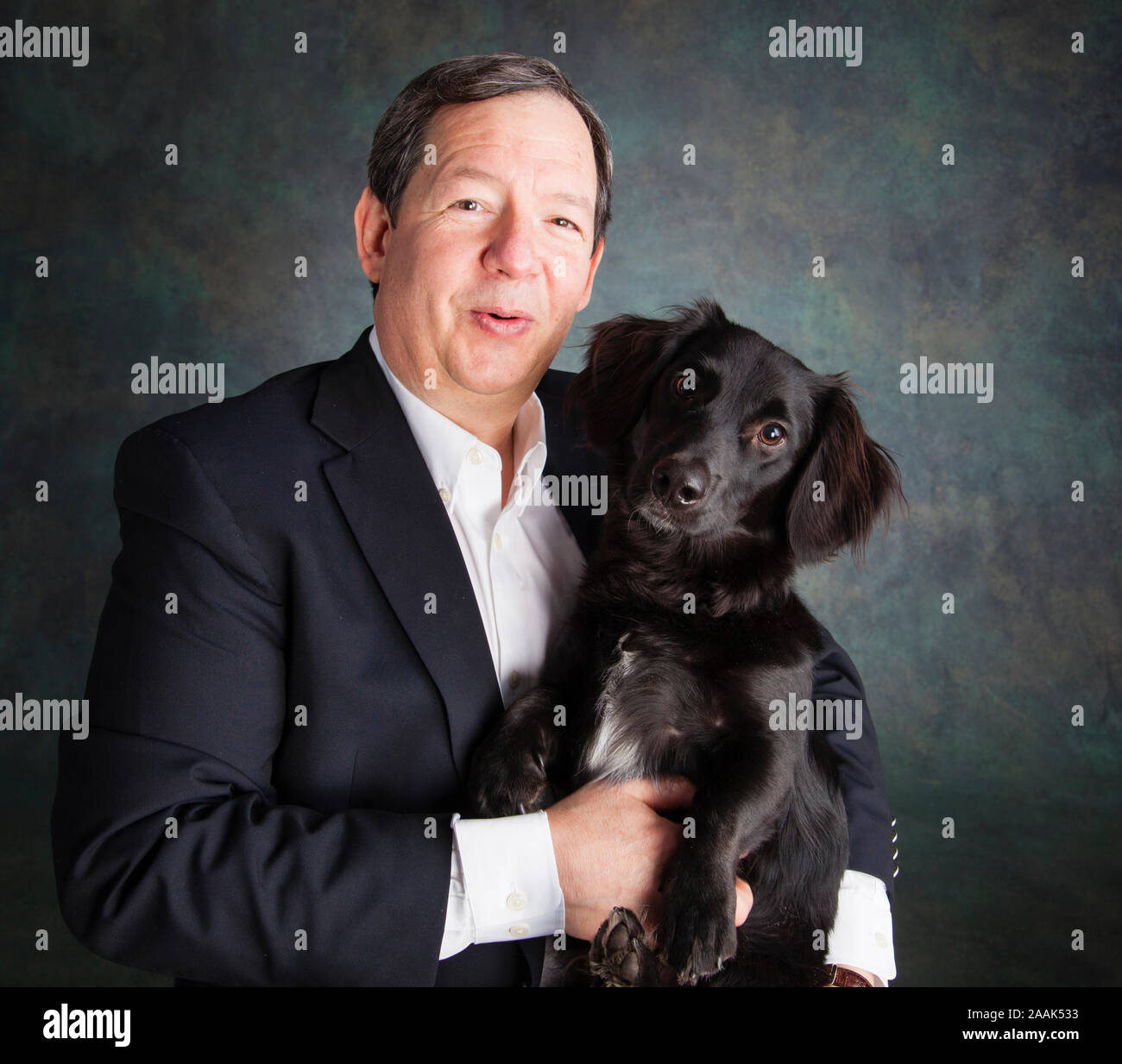 Studio portrait of man with mixed breed dog Stock Photo