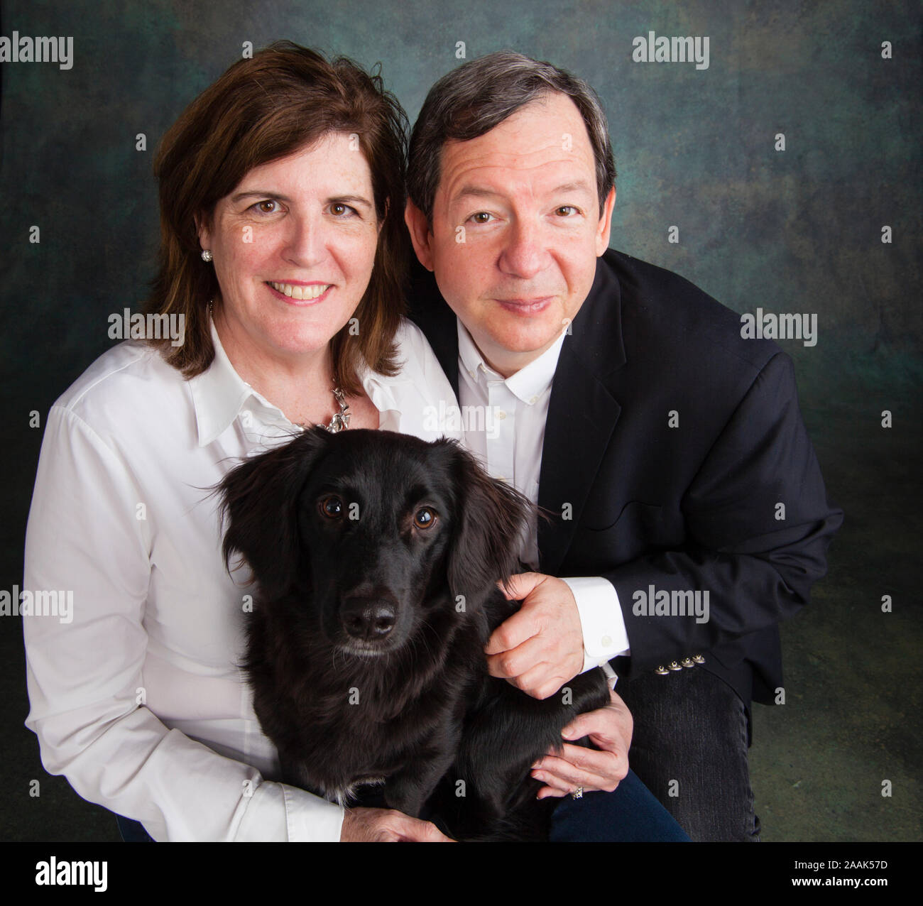 Studio portrait of mature couple with mixed breed dog Stock Photo