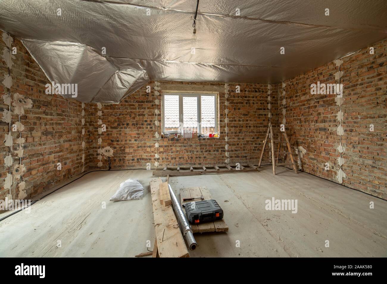Interior Of Unfinished Brick House With Concrete Floor And