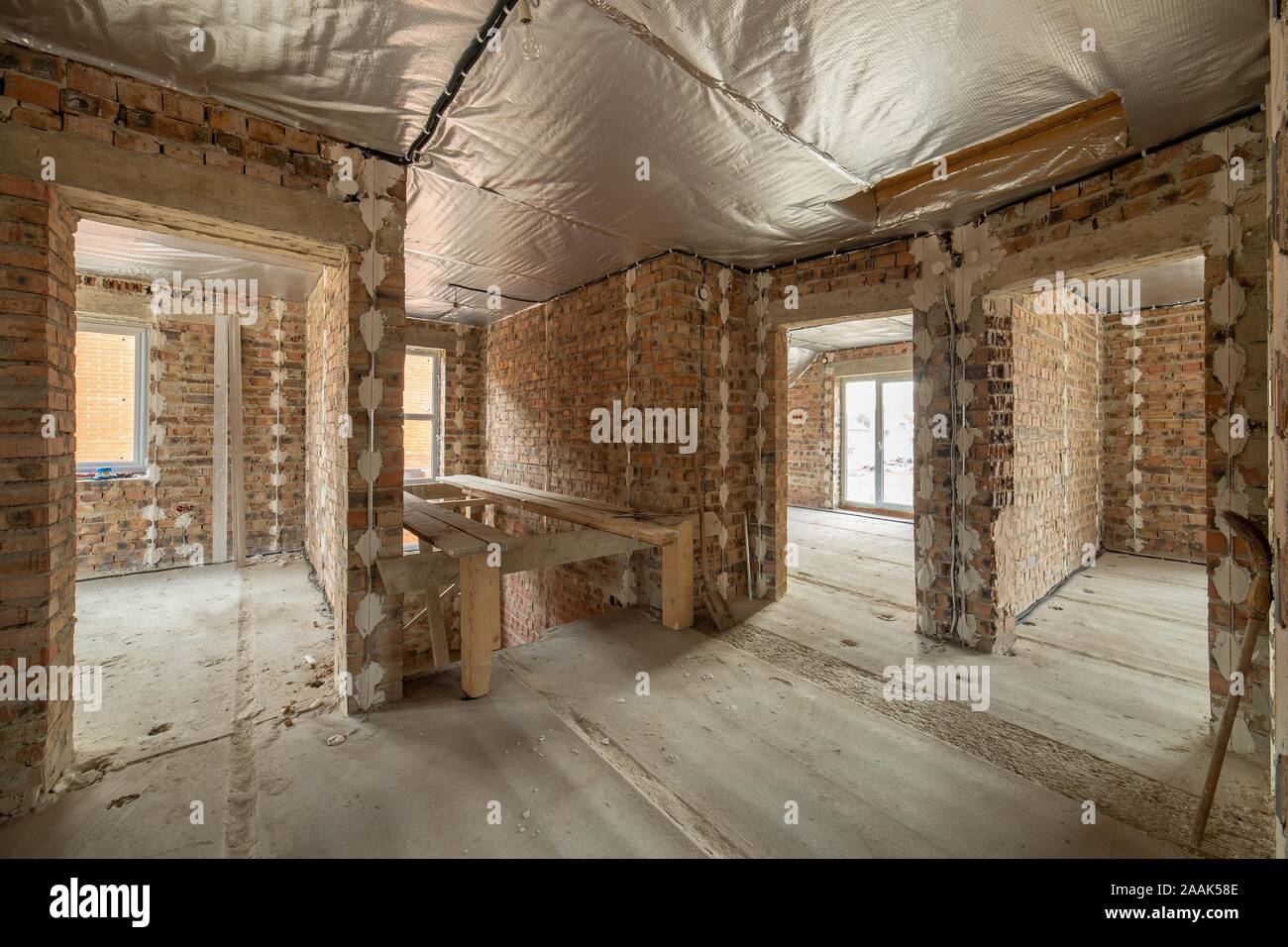 Interior Of Unfinished Brick House With Concrete Floor And