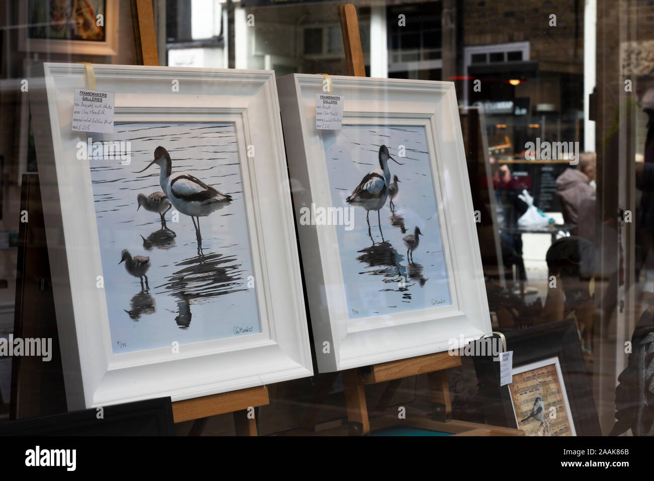 paintings by local artist for sell displayed in gallery window with