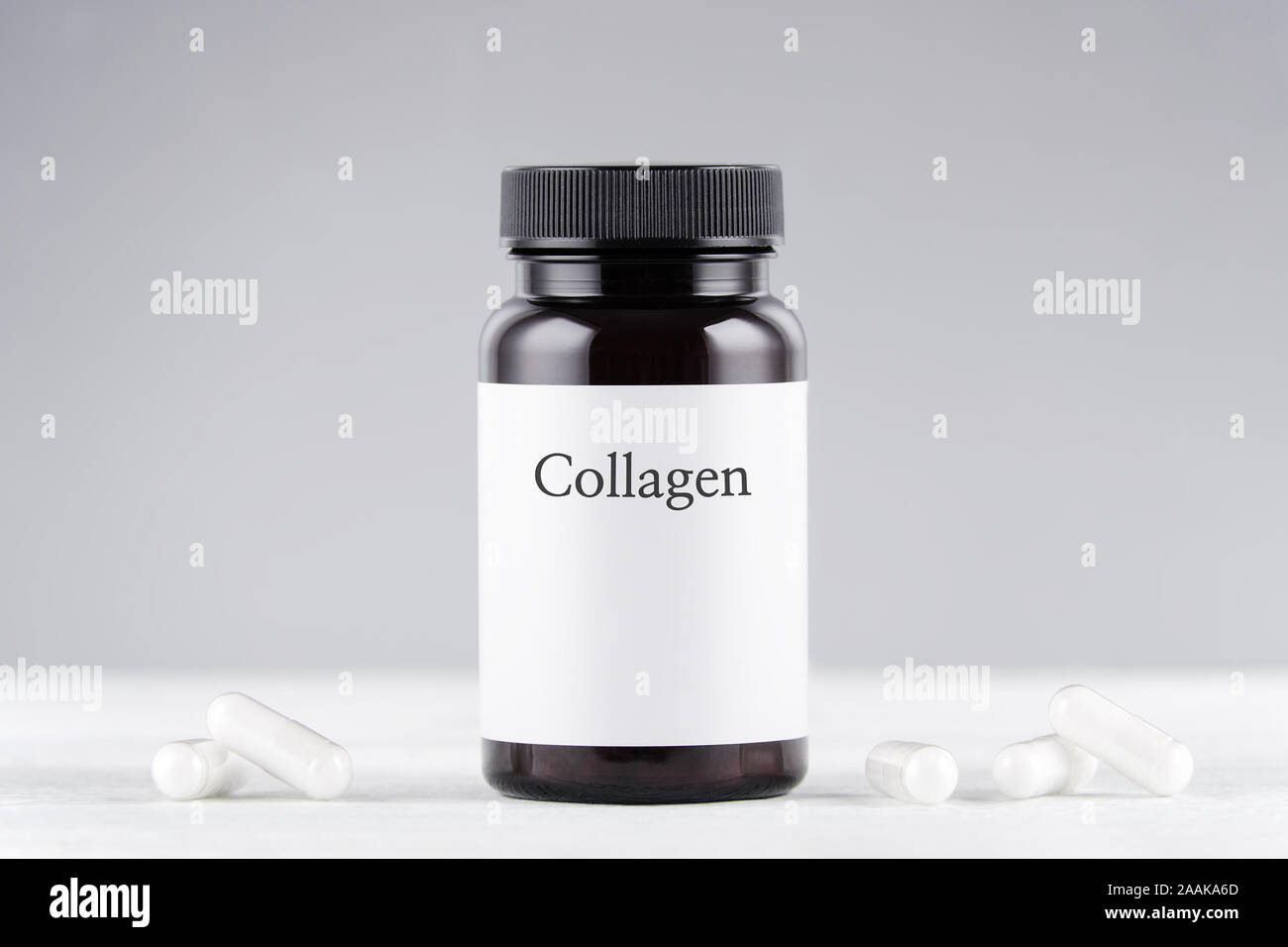 nutritional supplement collagen bottle and capsules on gray Stock Photo
