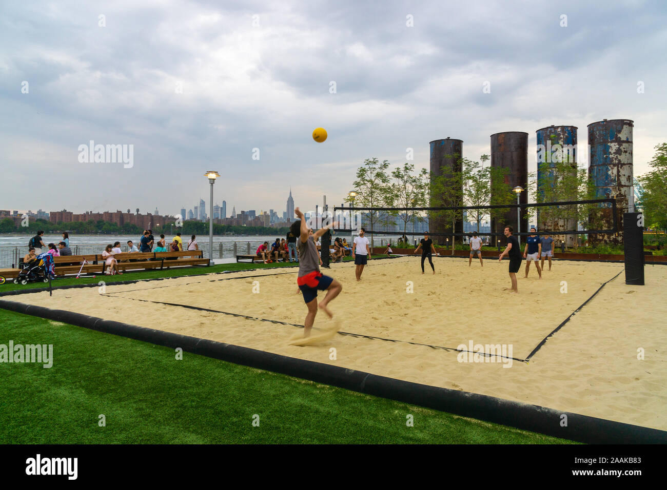 New York, USA - August 20, 2018: some boys playing volleyball in Domino Park, Williamsburg neighborhood of Brooklyn, New York City Stock Photo