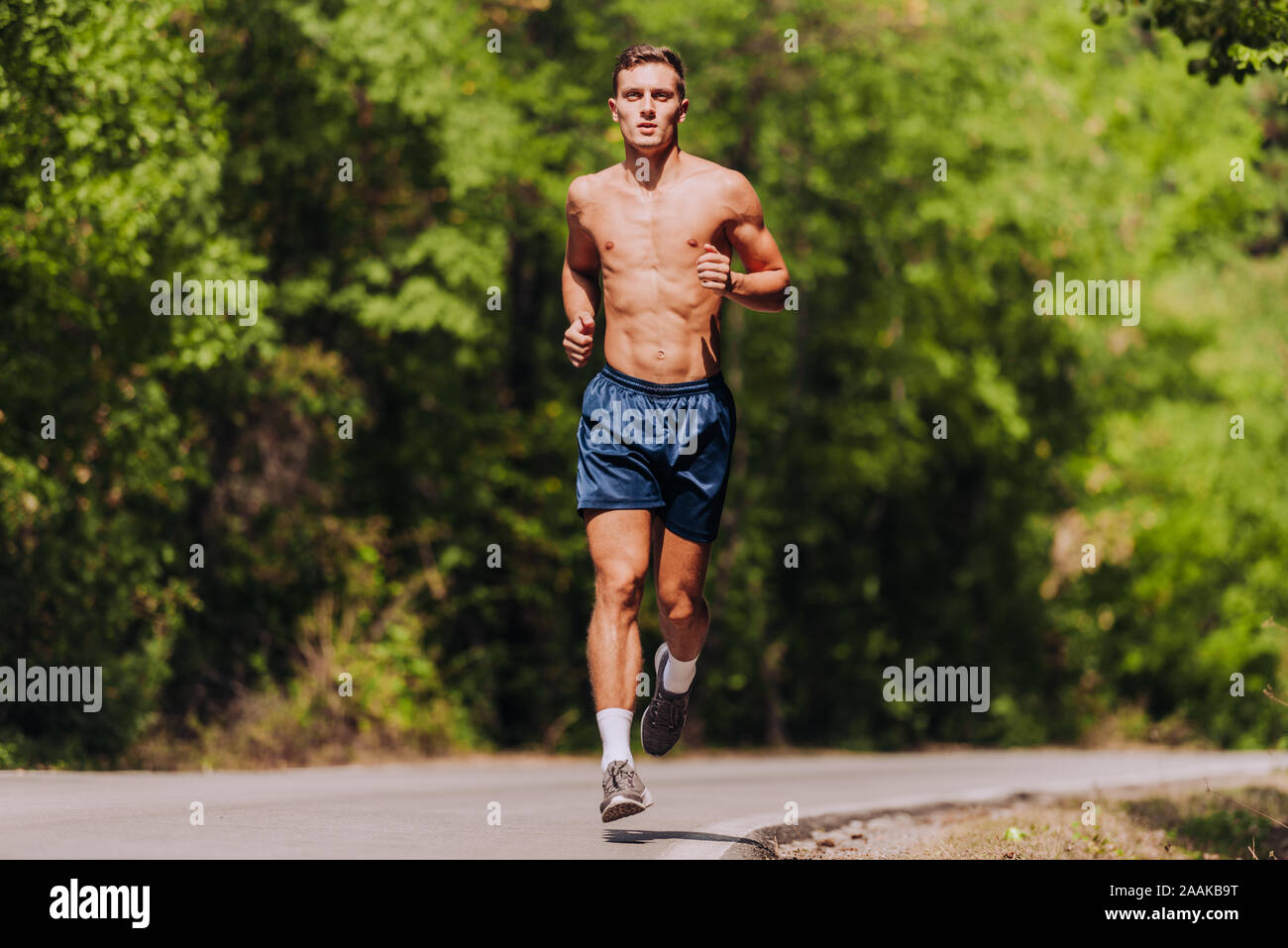Running man. Male runner at sprinting speed training for marathon outdoors  in amazing landscape. Strong and fit caucasian male fitness model Stock  Photo - Alamy