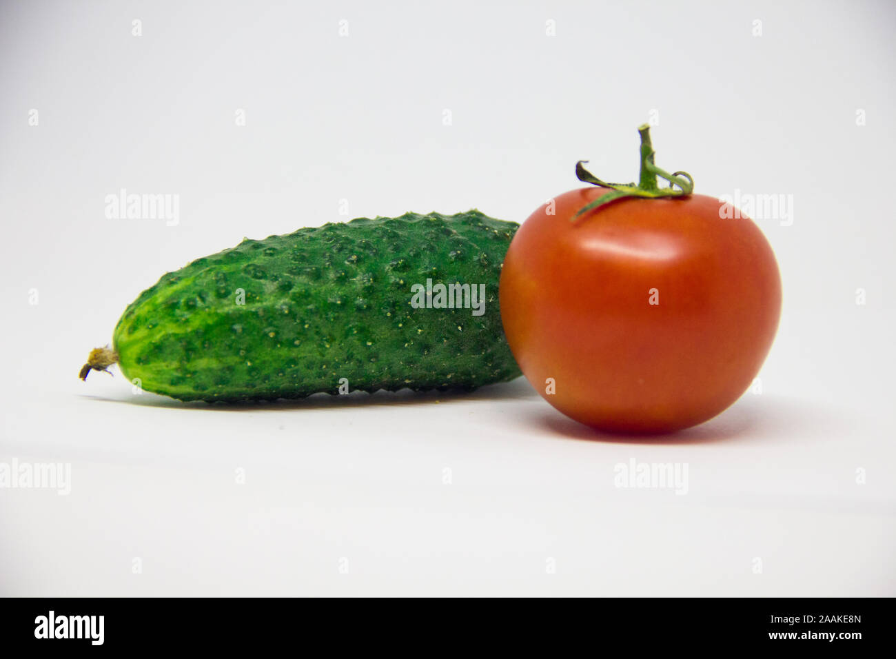 tomato and cucumber on a white background Stock Photo - Alamy