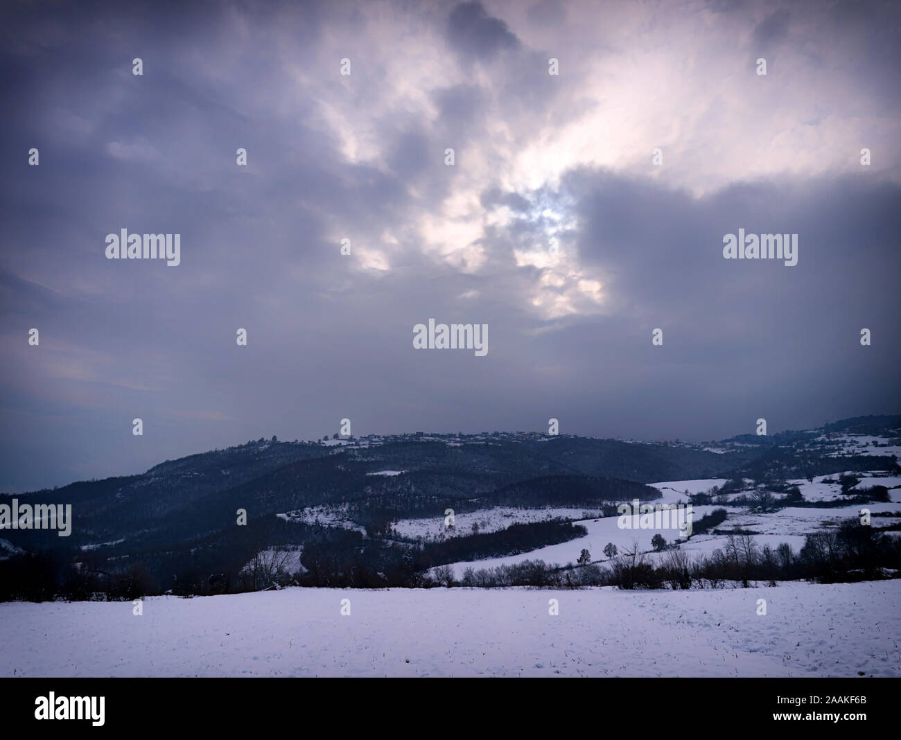Soft focus dreamy winter landscape. Mountains and land covered in snow, Pieria, Greece. Stock Photo