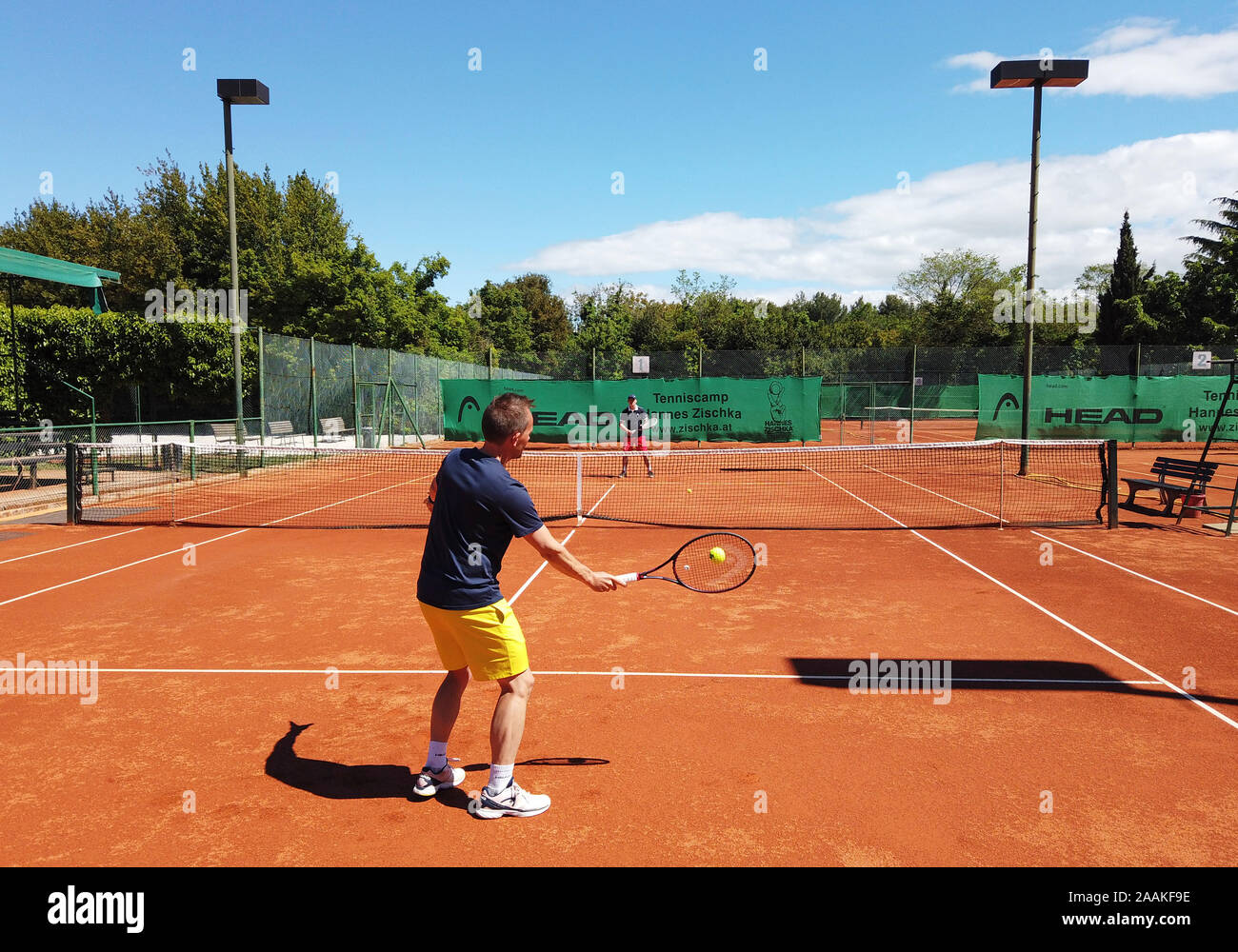 Men playing tennis on a clay court in Rovinj, Istria, Croatia Stock Photo -  Alamy