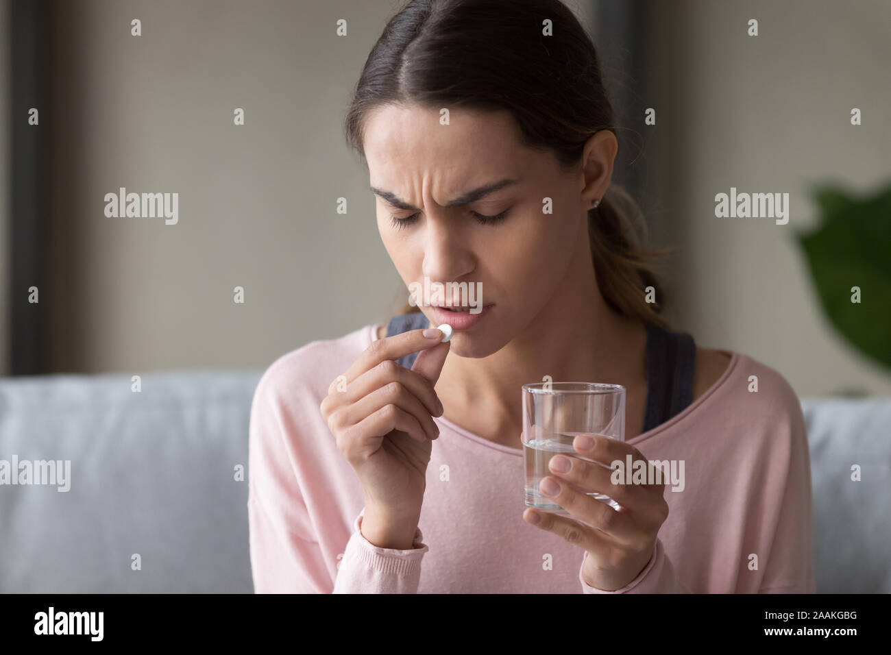 Unwell young woman consider having prescribed medication Stock Photo