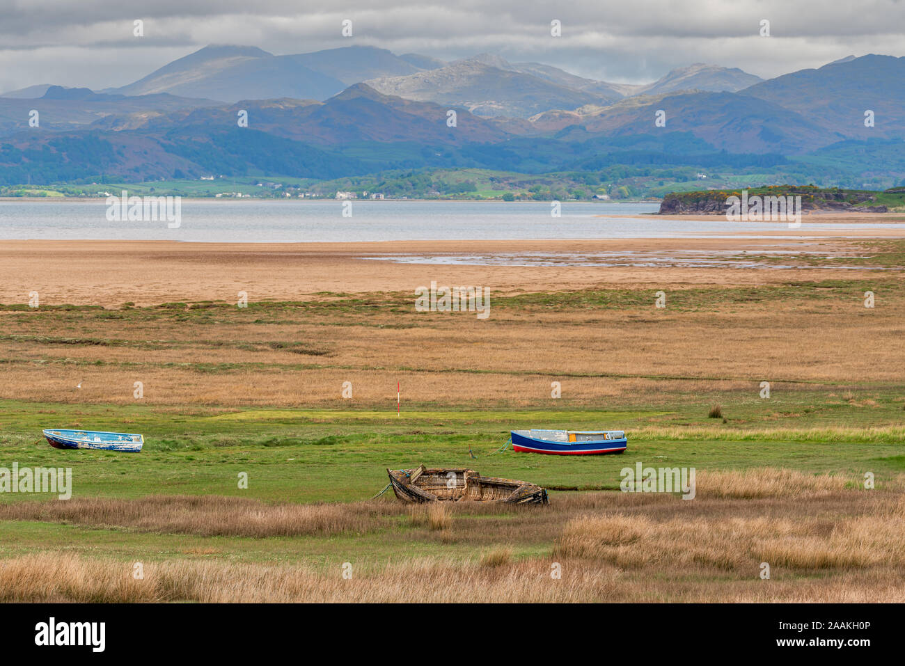 Boats in the grass, with clouds over the Lake District National Park in