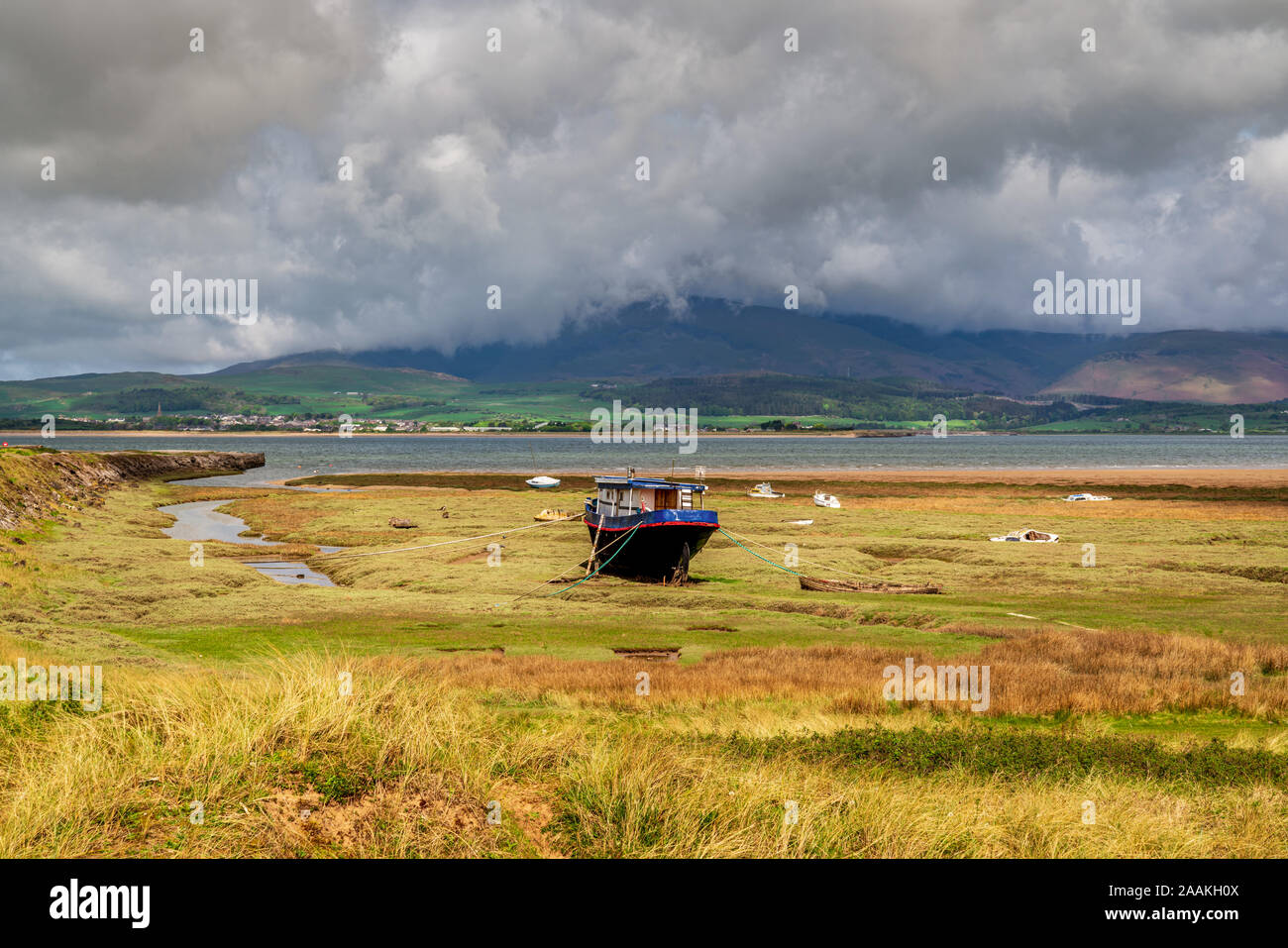 Boats in the grass, with clouds over the Lake District National Park in