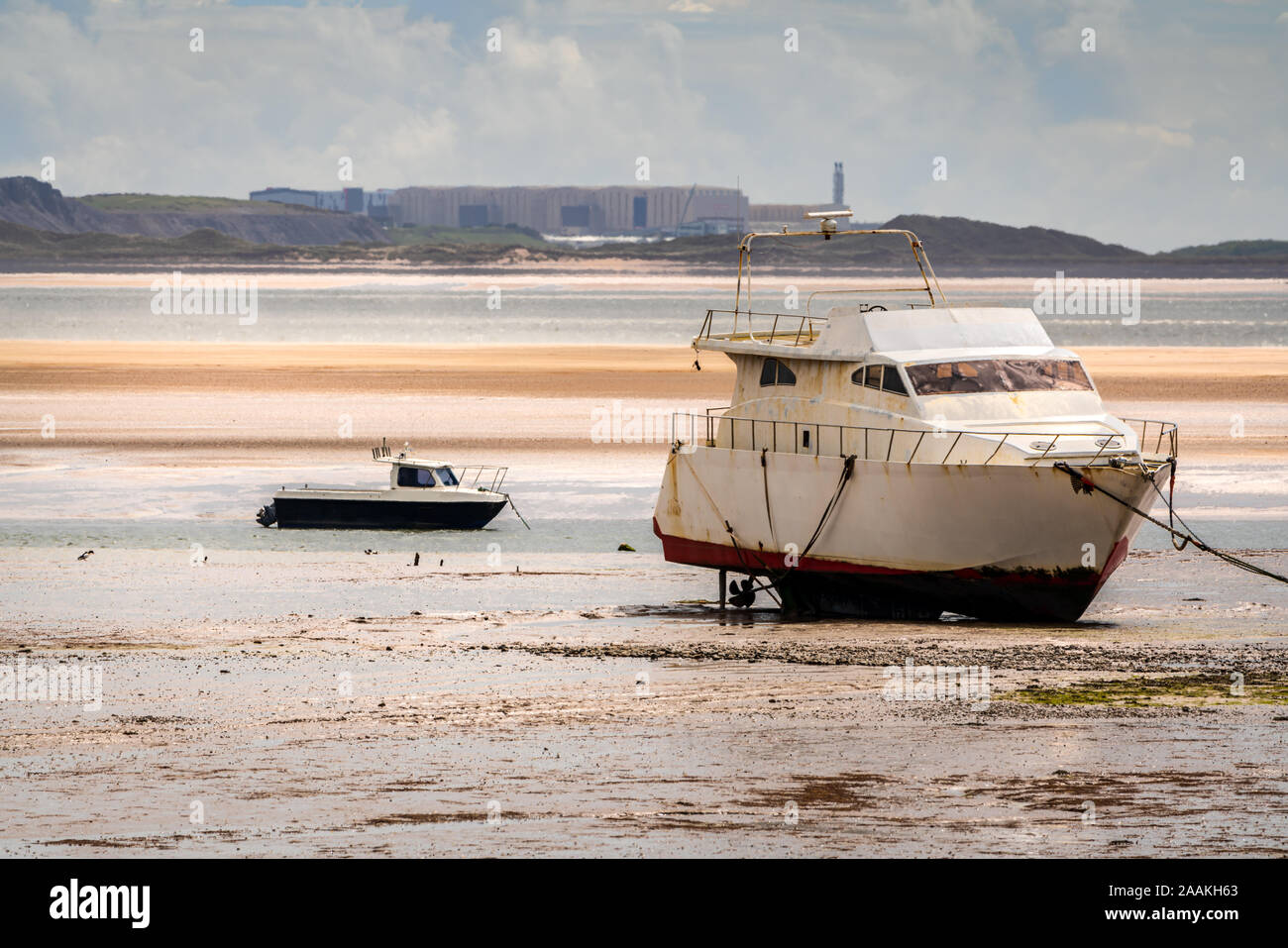 Two boats in the low tide, seen in Haverigg, Cumbria, England, UK Stock