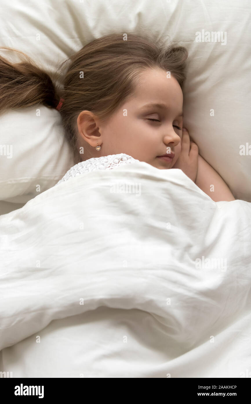 Top view of calm little child sleep in cozy bed Stock Photo