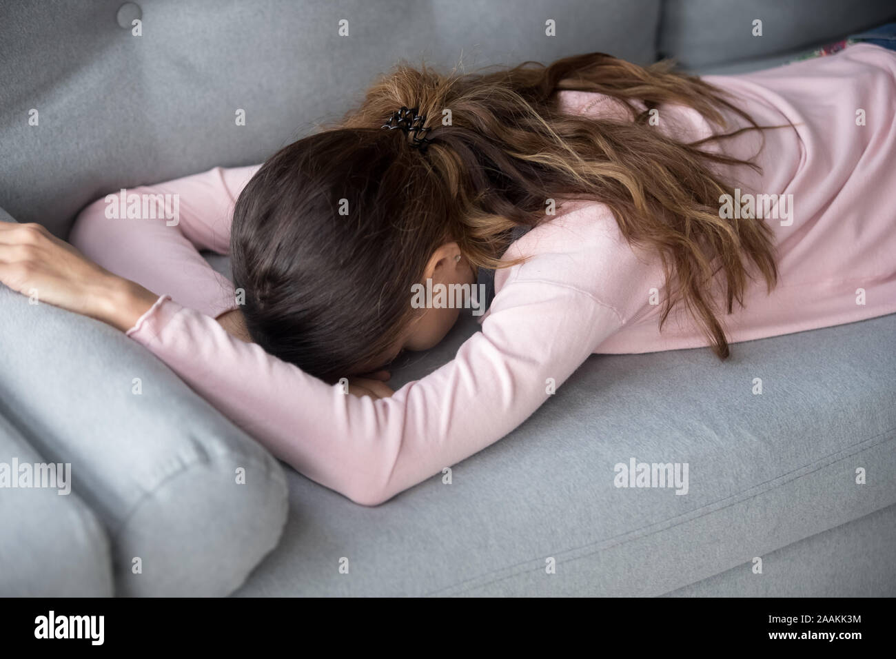 Girl lying on sofa hi-res stock photography and images - Alamy