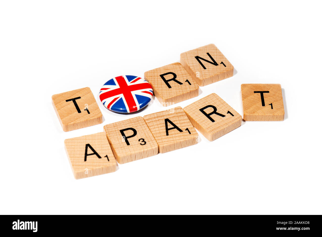 Conceptual: Scrabble letters spell out TORN APART with a Union Flag pin badge as the O. Stock Photo
