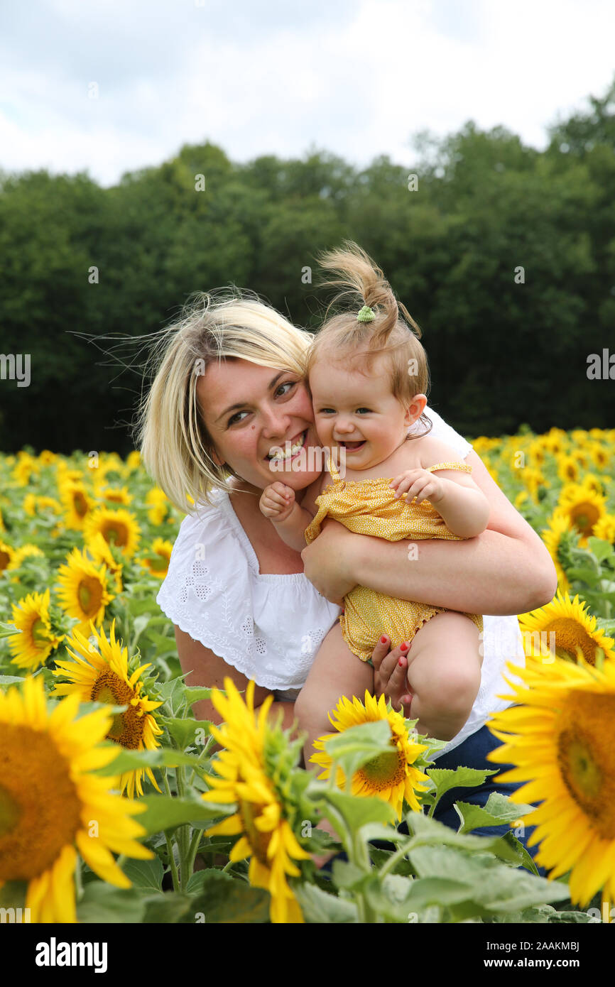 Mother and baby in a sunflower field, France Stock Photo - Alamy