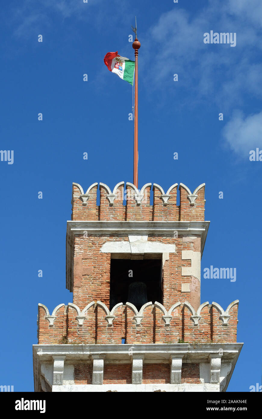 Tower of the historic Venetian Arsenal and Naval Museum in Castello district of Venice with Italian flag - Italy. Stock Photo