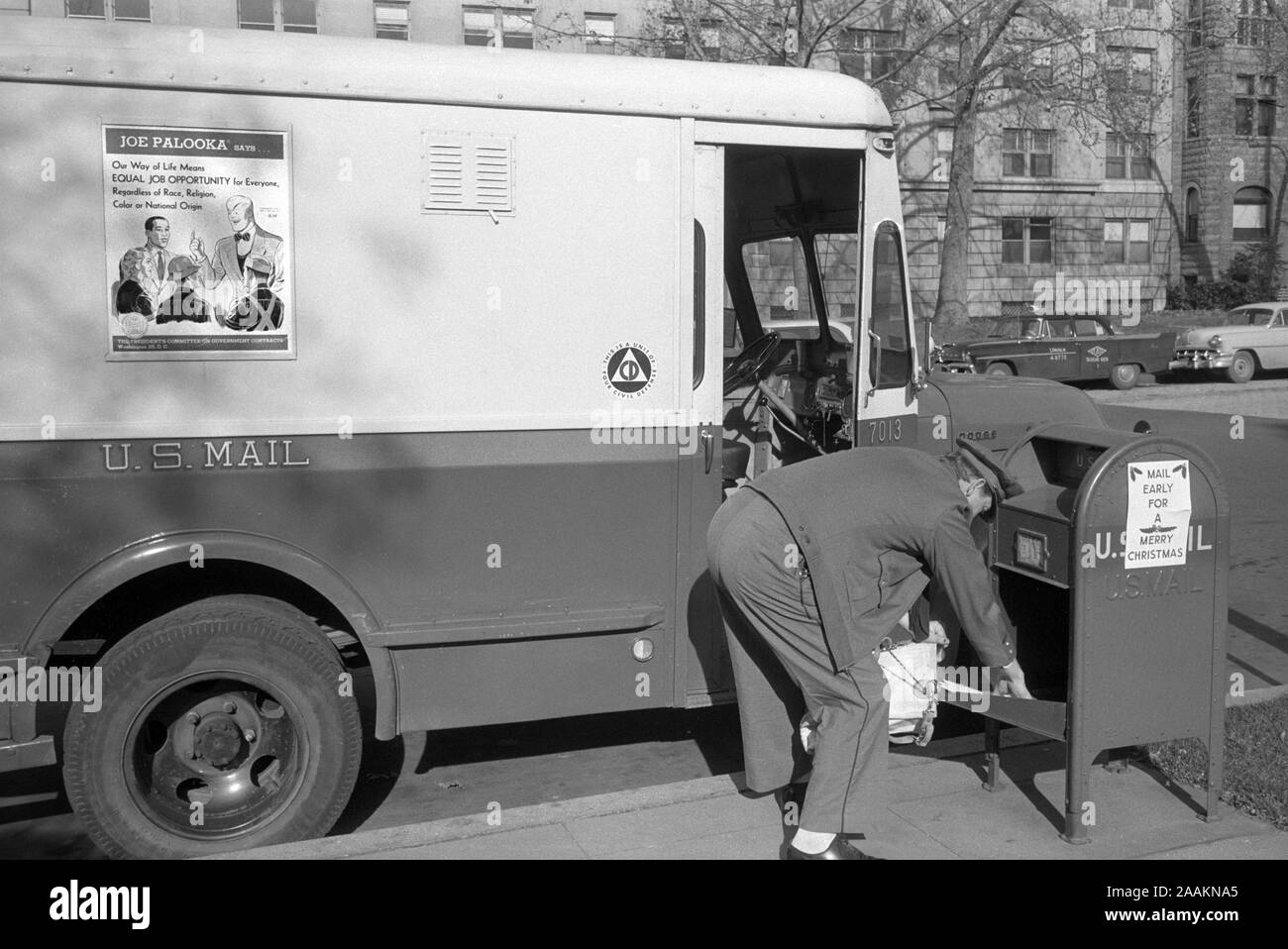 Mailman picking up Mail from Mailbox, Job Opportunity Poster on Side of Mail Truck, Washington, D.C., USA, photograph by Thomas J. O'Halloran, February 1957 Stock Photo