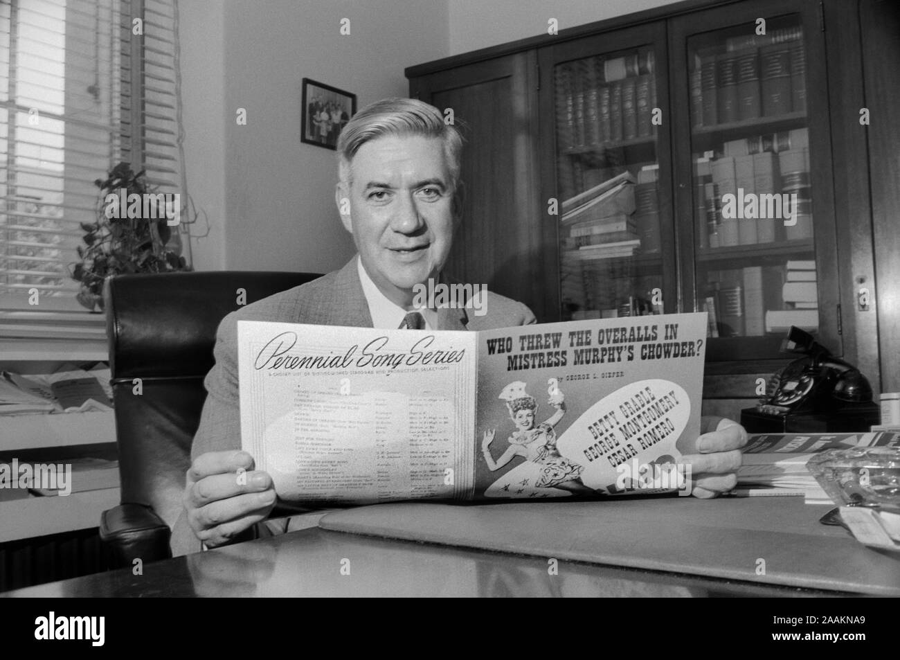 Massachusetts Congressman Thomas P. 'Tip' O'Neill, Half-Length Portrait sitting at Office Desk and holding Sheet Music, Washington, D.C., USA, photograph by Thomas J. O'Halloran, August 1957 Stock Photo