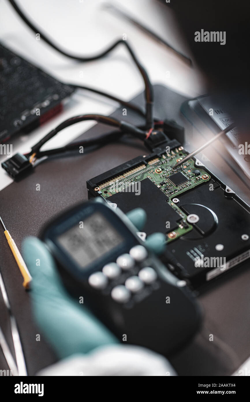 Digital forensic science. Police forensic analyst examining computer