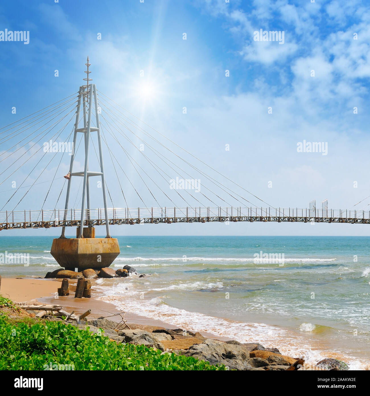 The bridge to the island, the ocean and the sun in the blue sky (Matara ...