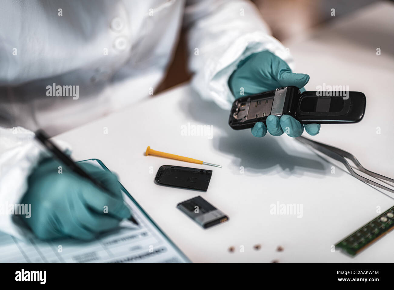 Digital forensic science. Police forensic analyst examining confiscated